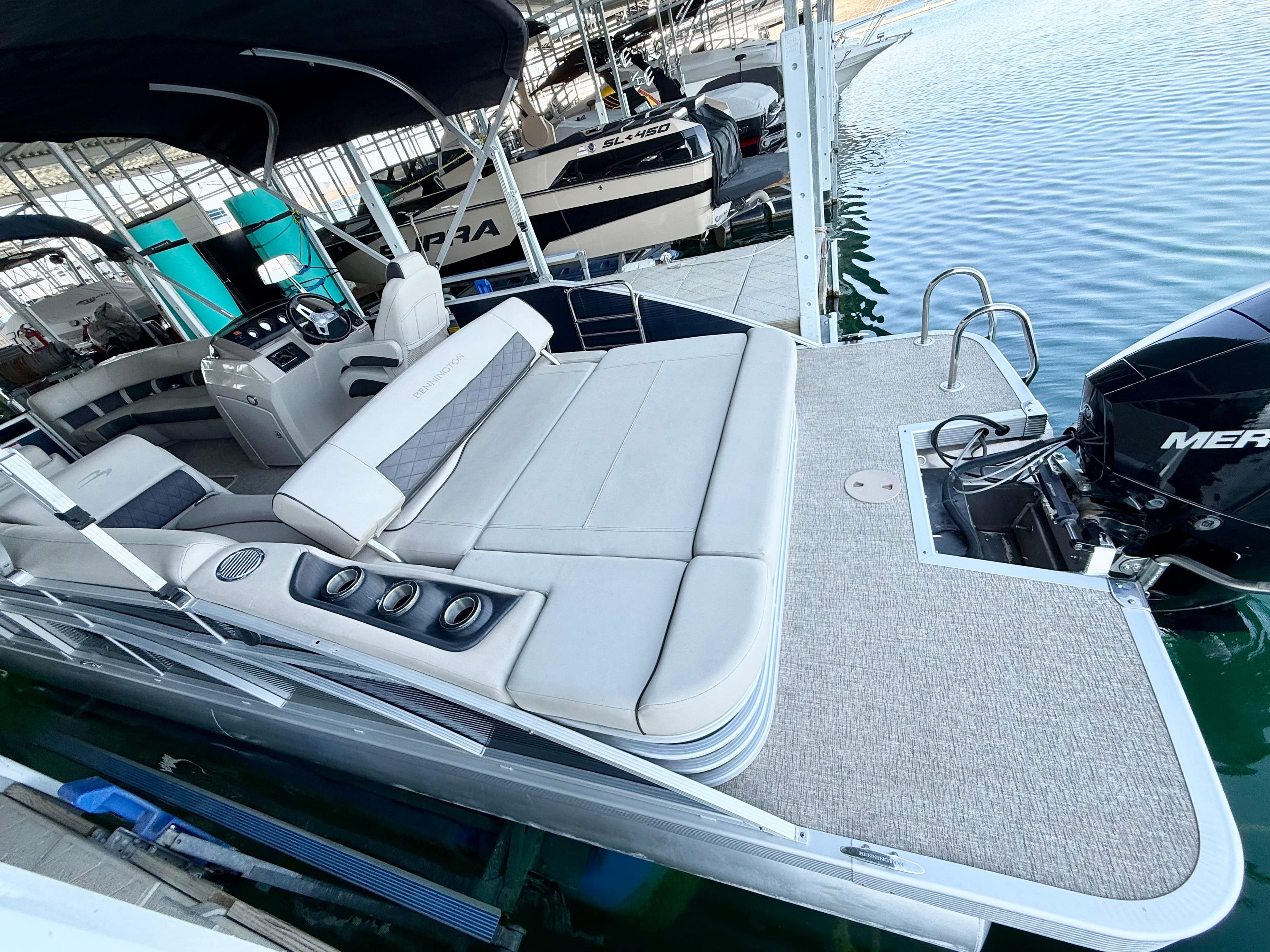 2019 Bennington SX 25 Premium Swingback pontoon boat with spacious seating and outboard motor.