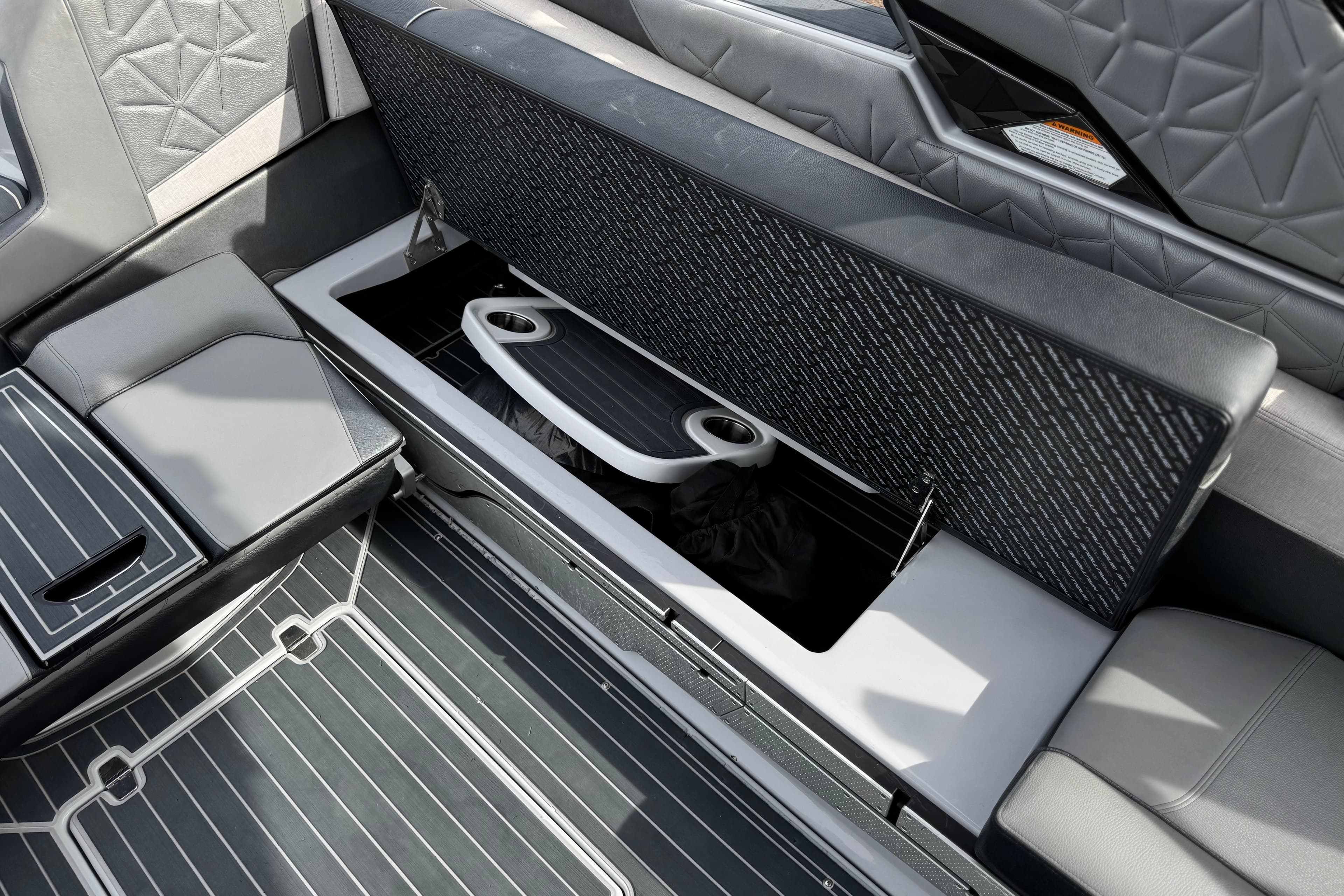 2022 Nautique Super Air Nautique G25 Paragon interior storage compartment with sleek seating design.