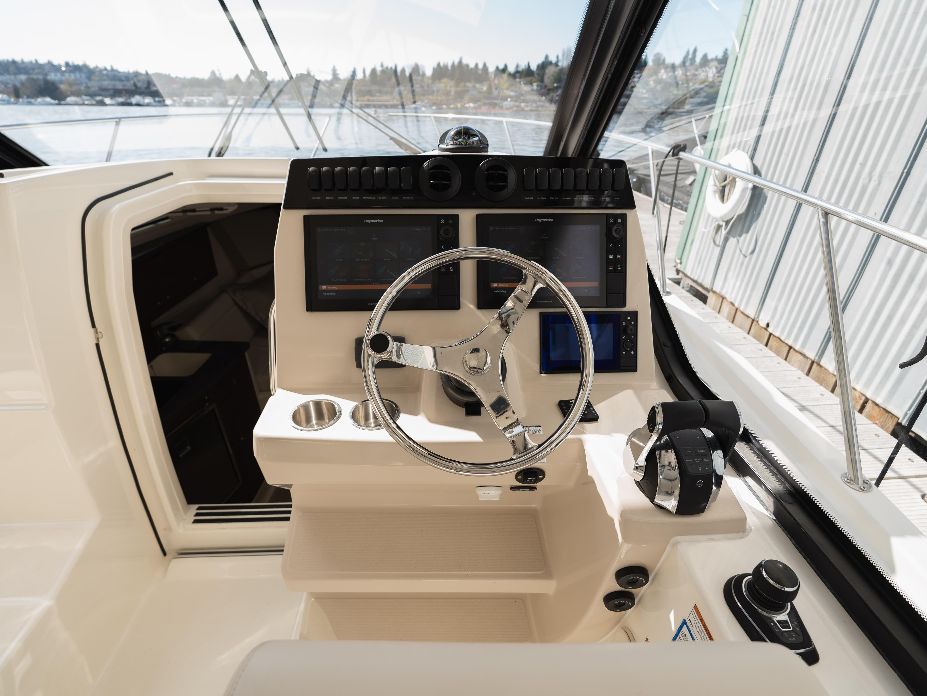 2020 Boston Whaler 325 Conquest Pilothouse helm with modern controls and navigation screens.