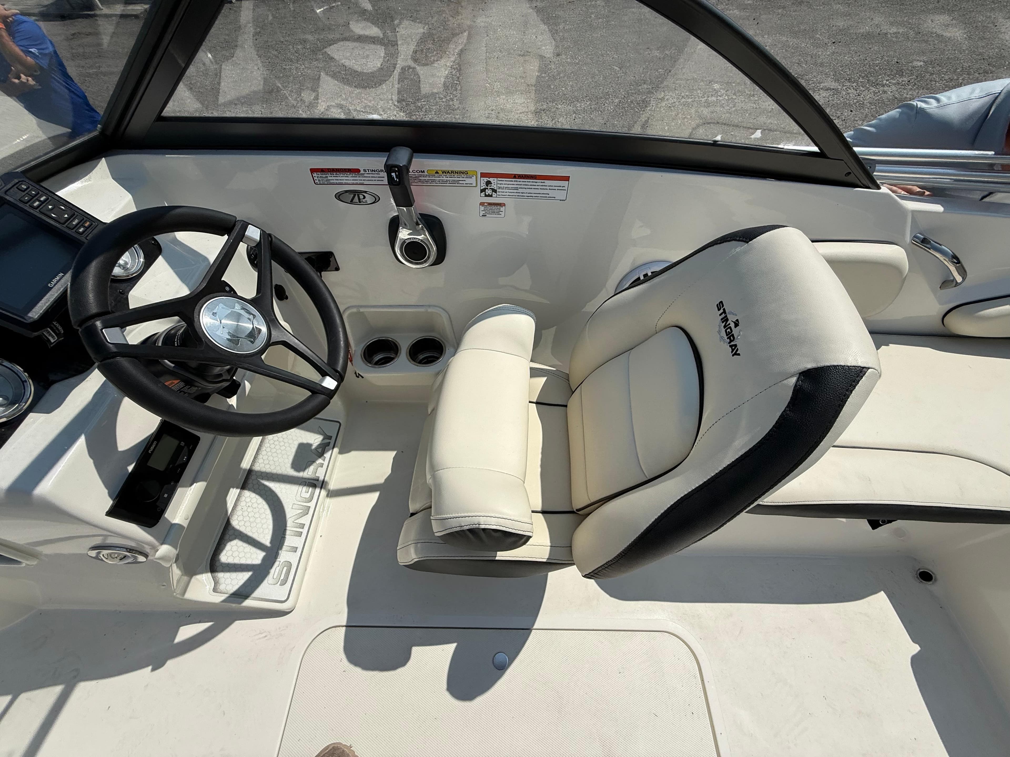 2023 Stingray 191 DC boat interior with steering wheel and comfortable seating.
