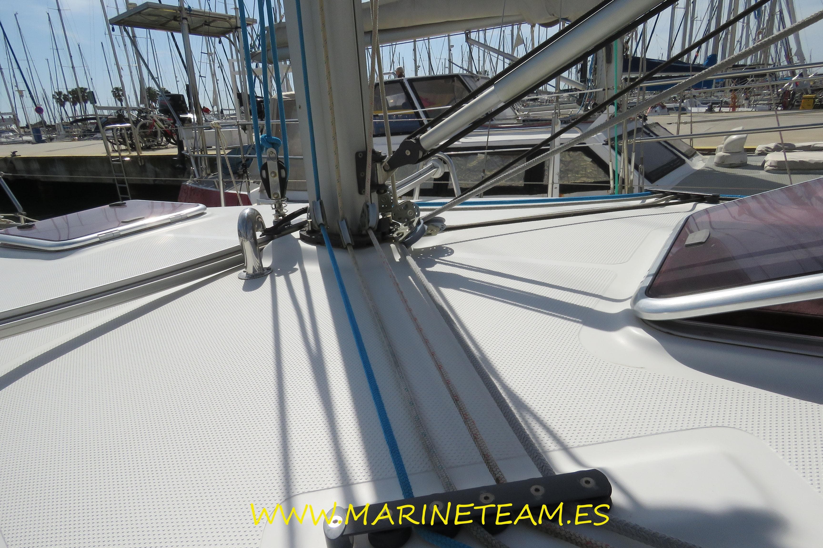 Deck view of 2007 Hanse 342 sailboat in marina, featuring rigging and hatches.