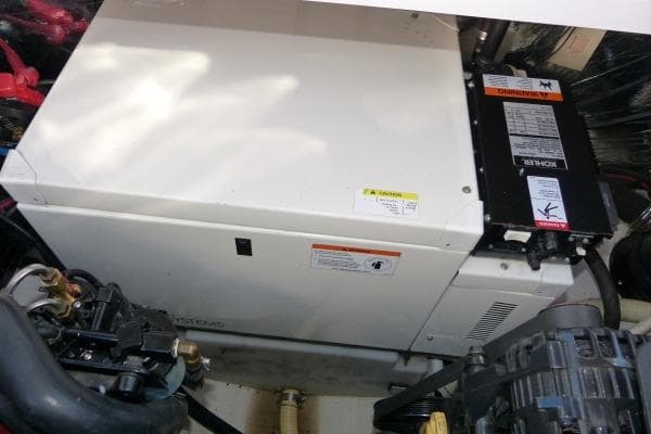 Engine compartment of 2004 Four Winns 298 Vista boat, featuring a generator system.