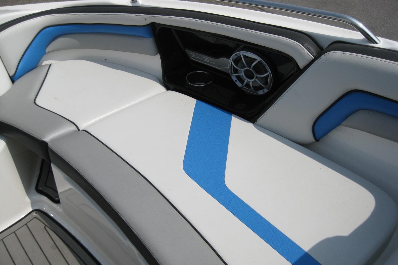 2018 Yamaha Boats 242X E-Series interior with blue and white seating and speaker system.