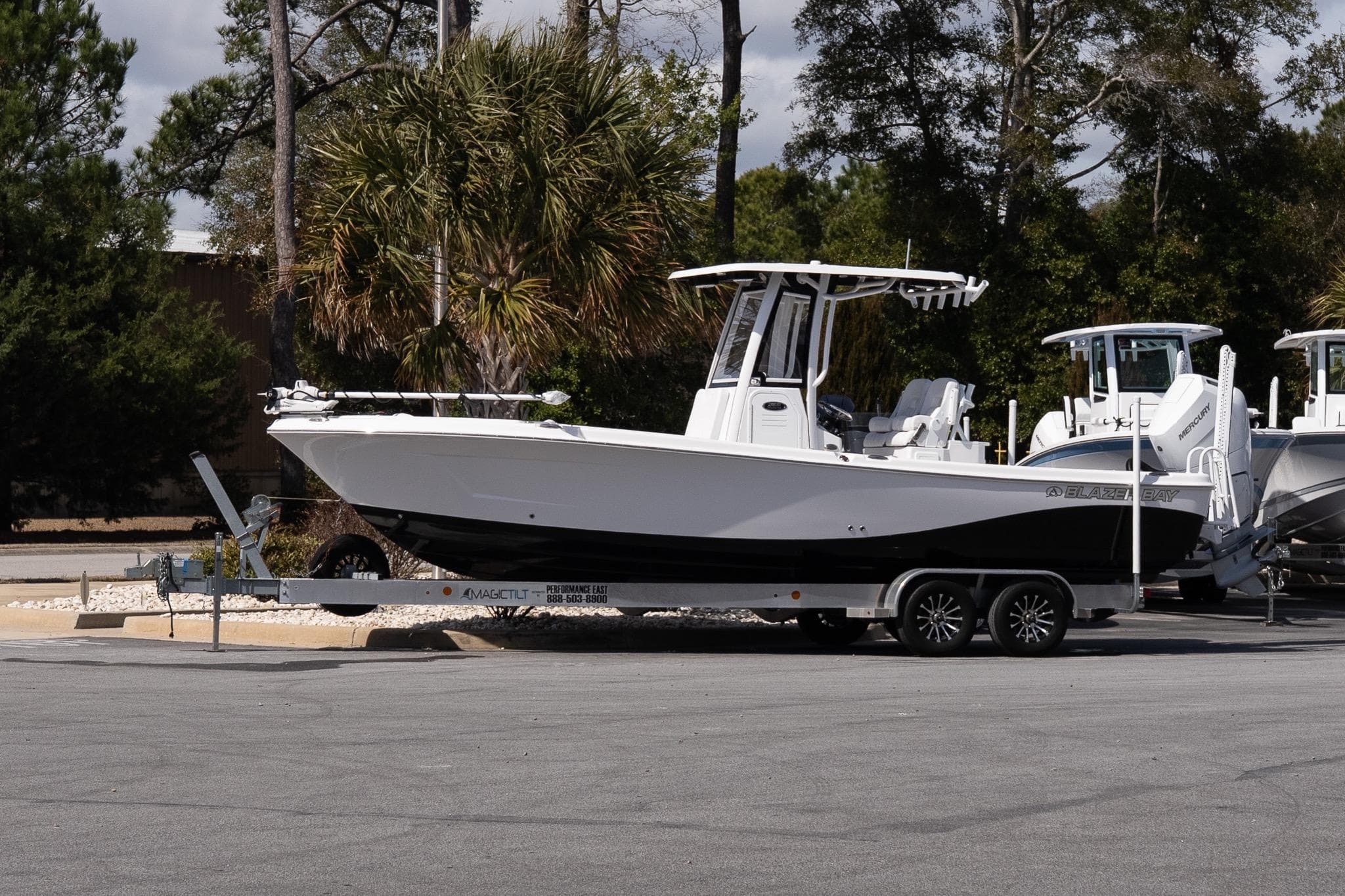 2026 Blazer Bay Makaira 2800 boat on trailer, parked outdoors.