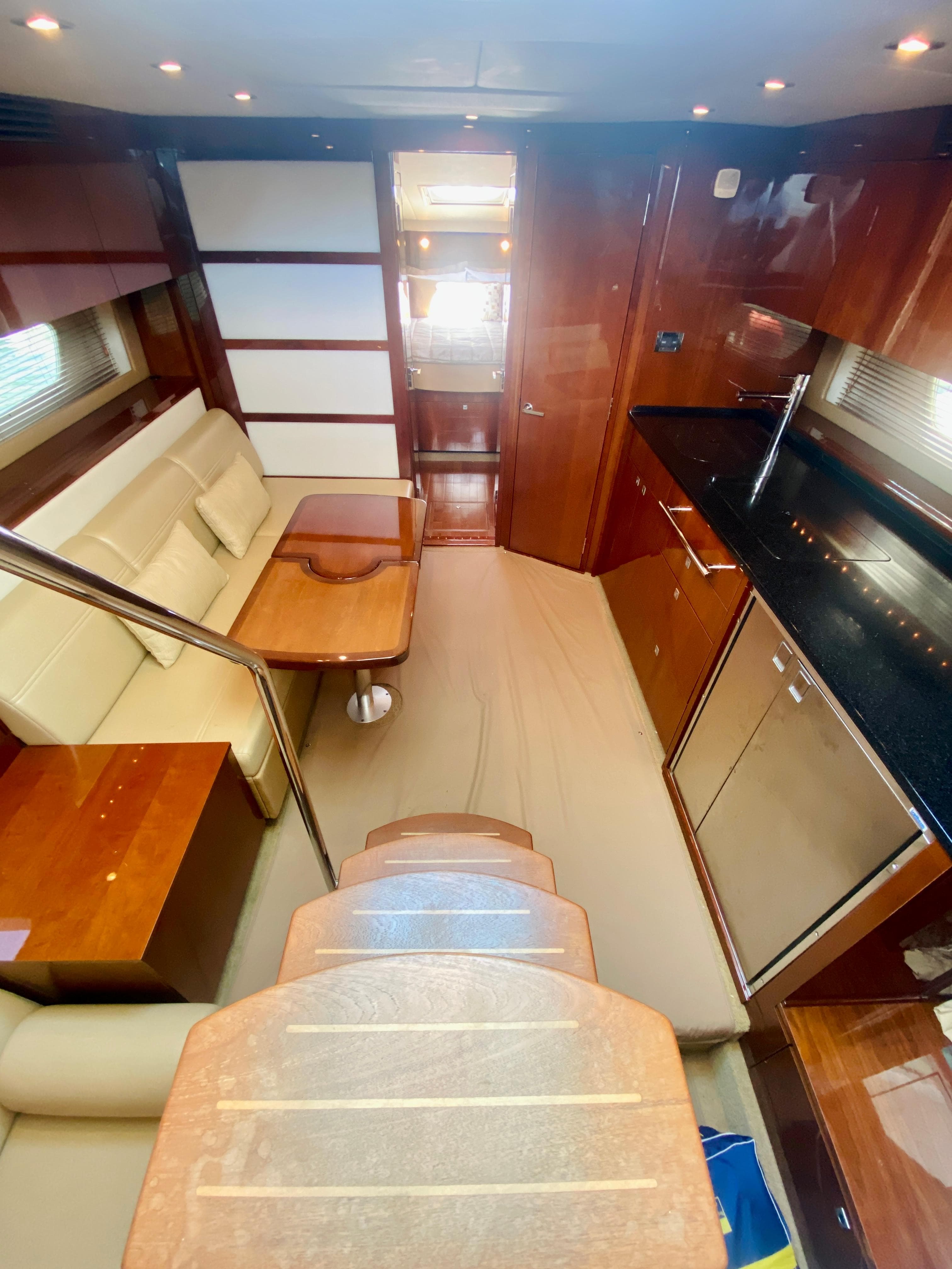 Interior of 2010 Sea Ray 450 Sundancer yacht with modern kitchen and dining area.