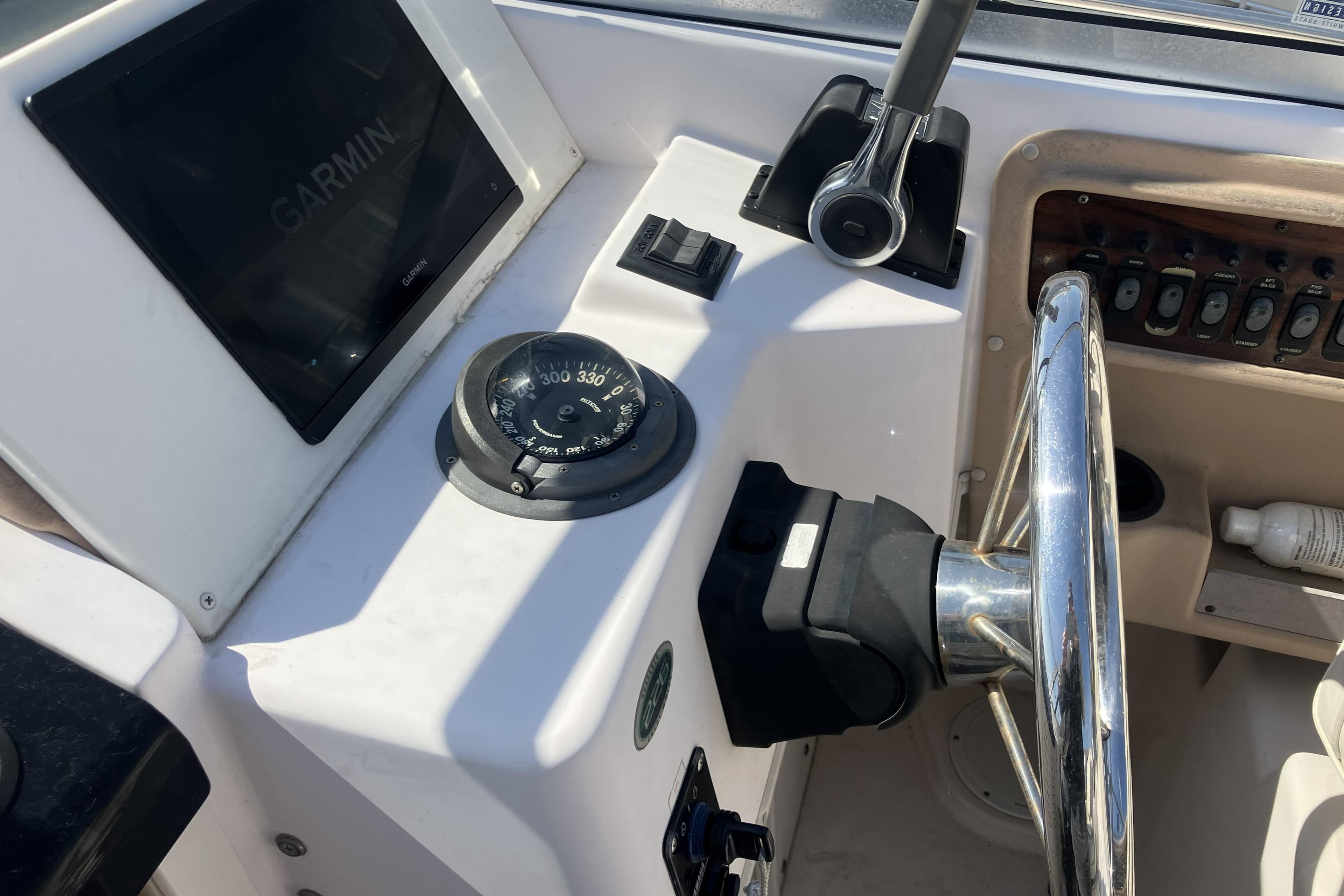 Grady-White Seafarer 226 boat dashboard with Garmin display and compass, 1998 model.