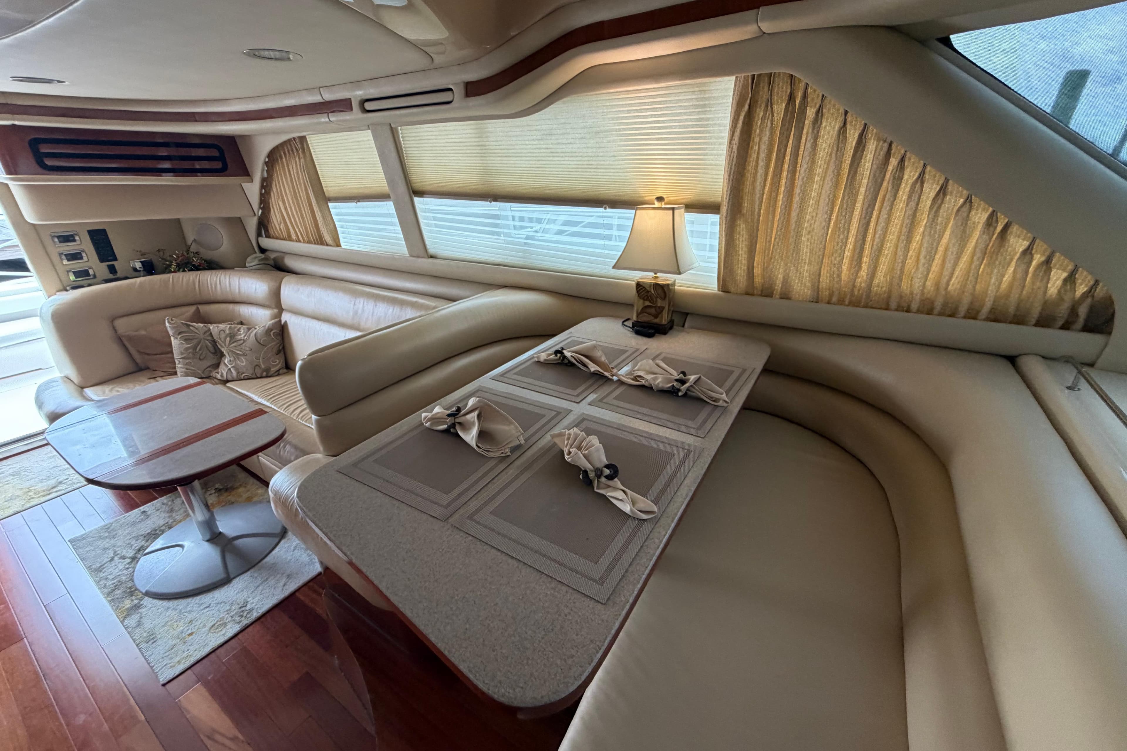 Luxurious interior of 2002 Sea Ray 480 Sedan Bridge yacht with elegant seating and dining area.