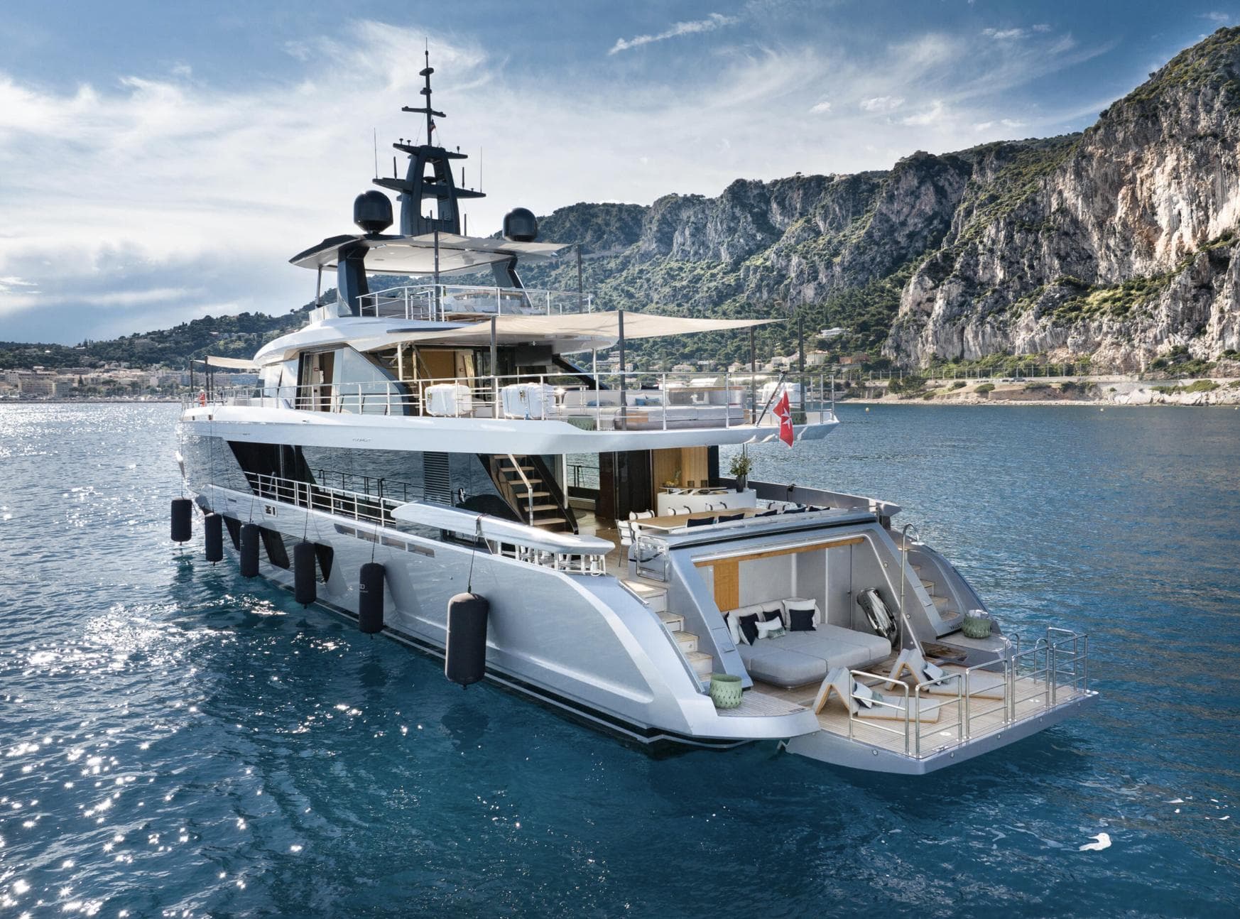 Luxurious 2023 Azimut Grande 36M yacht cruising near rocky coastline.