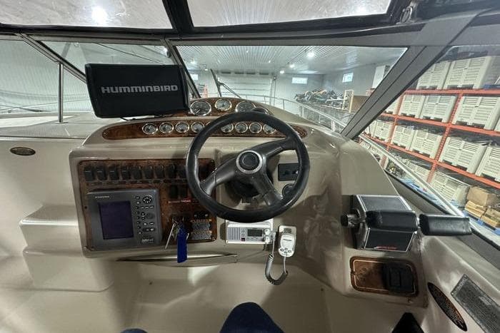 Cockpit of 2001 Maxum 3300 SCR boat with steering wheel and navigation equipment.
