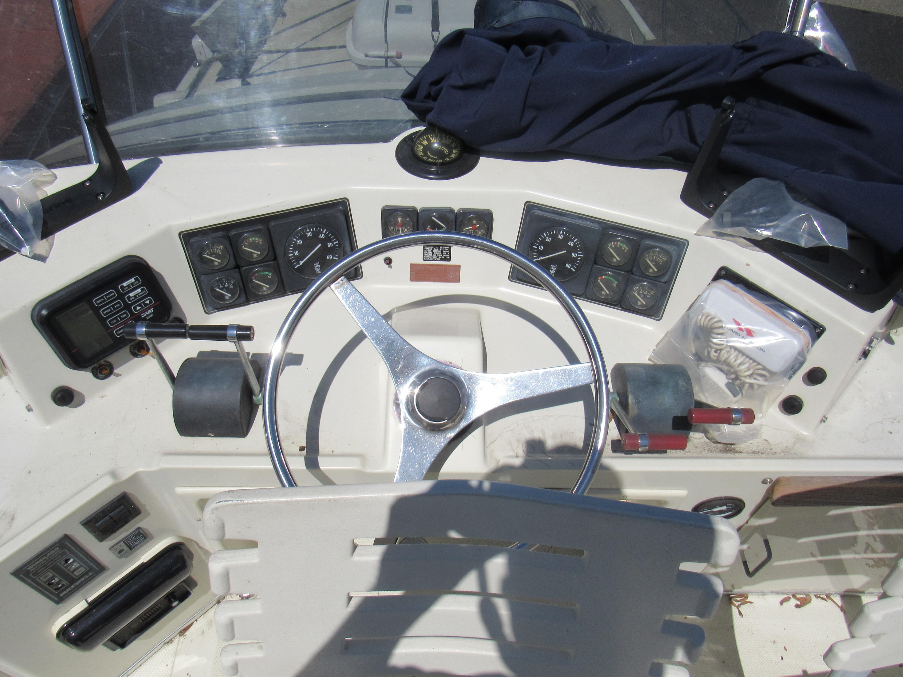 1989 Tollycraft Sport Sedan helm with steering wheel and instrument panel.