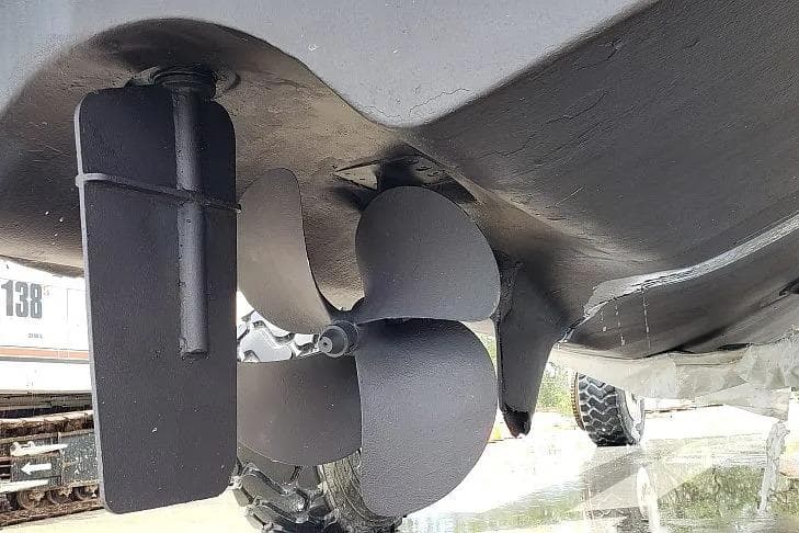 Propeller and rudder of 2014 Aquila 48 boat, close-up view.