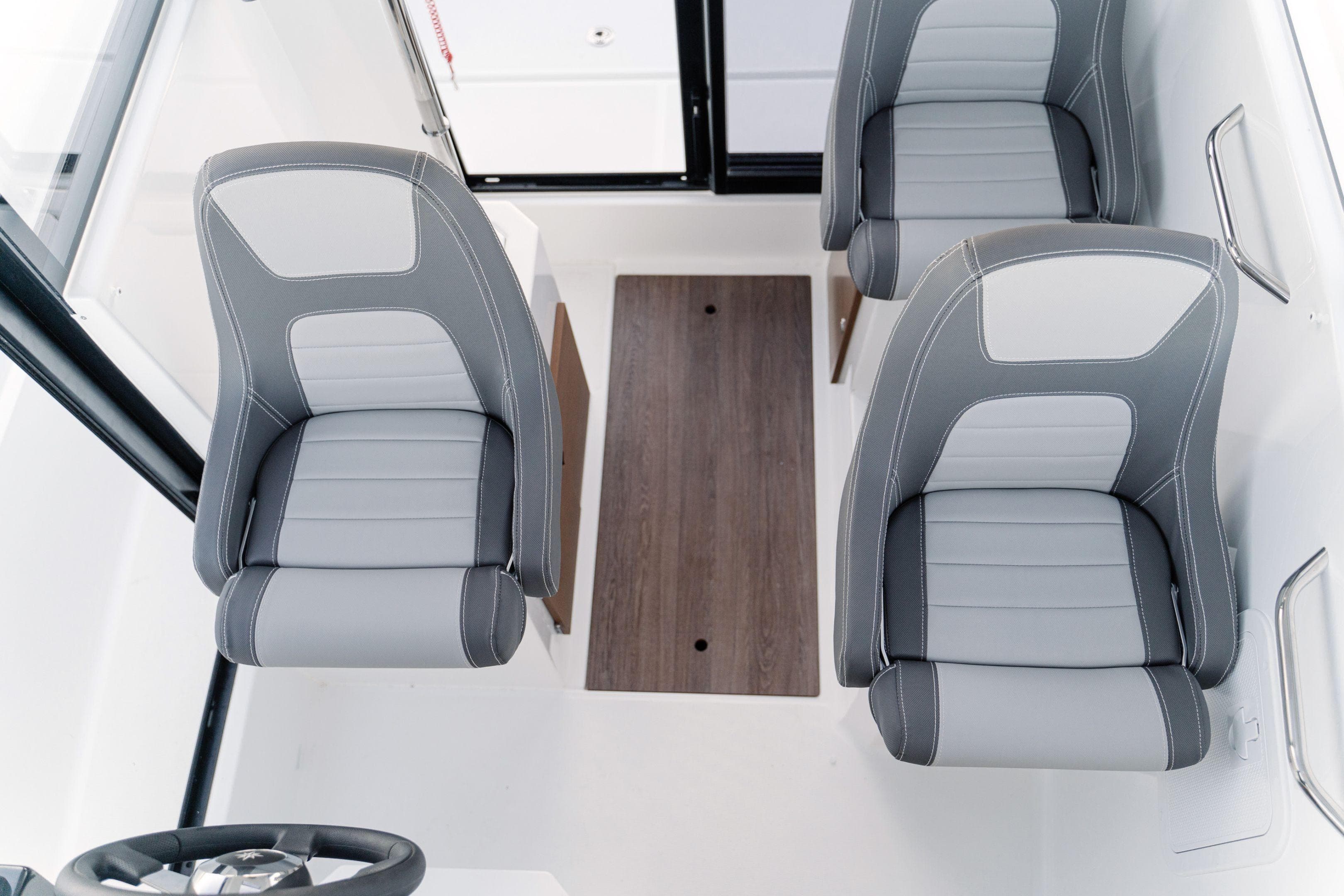 Interior of 2026 Jeanneau NC 695 Sport boat with three gray seats.