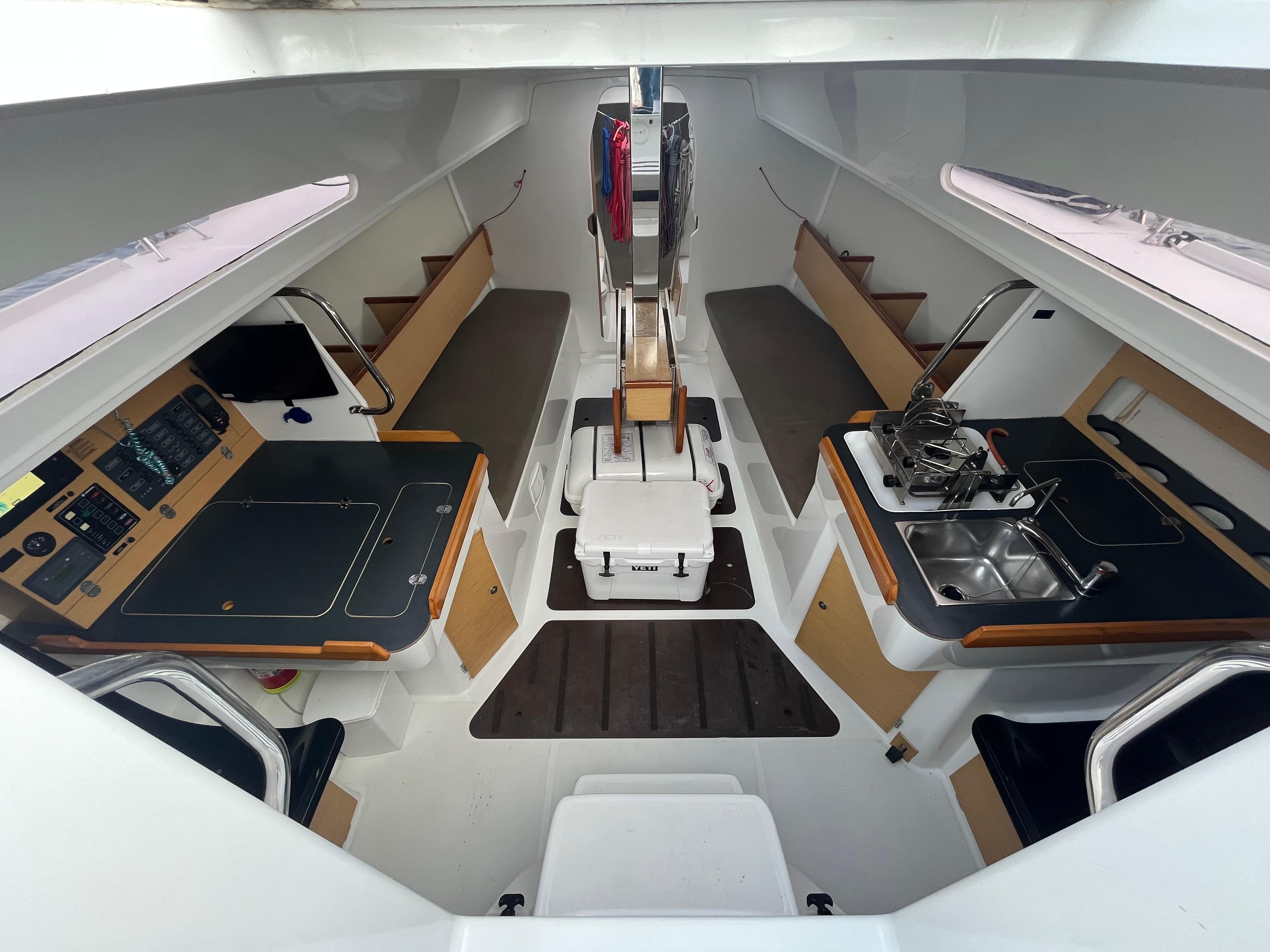 Interior of 2013 Jeanneau Sun Fast 3600 sailboat, featuring modern navigation and kitchen areas.