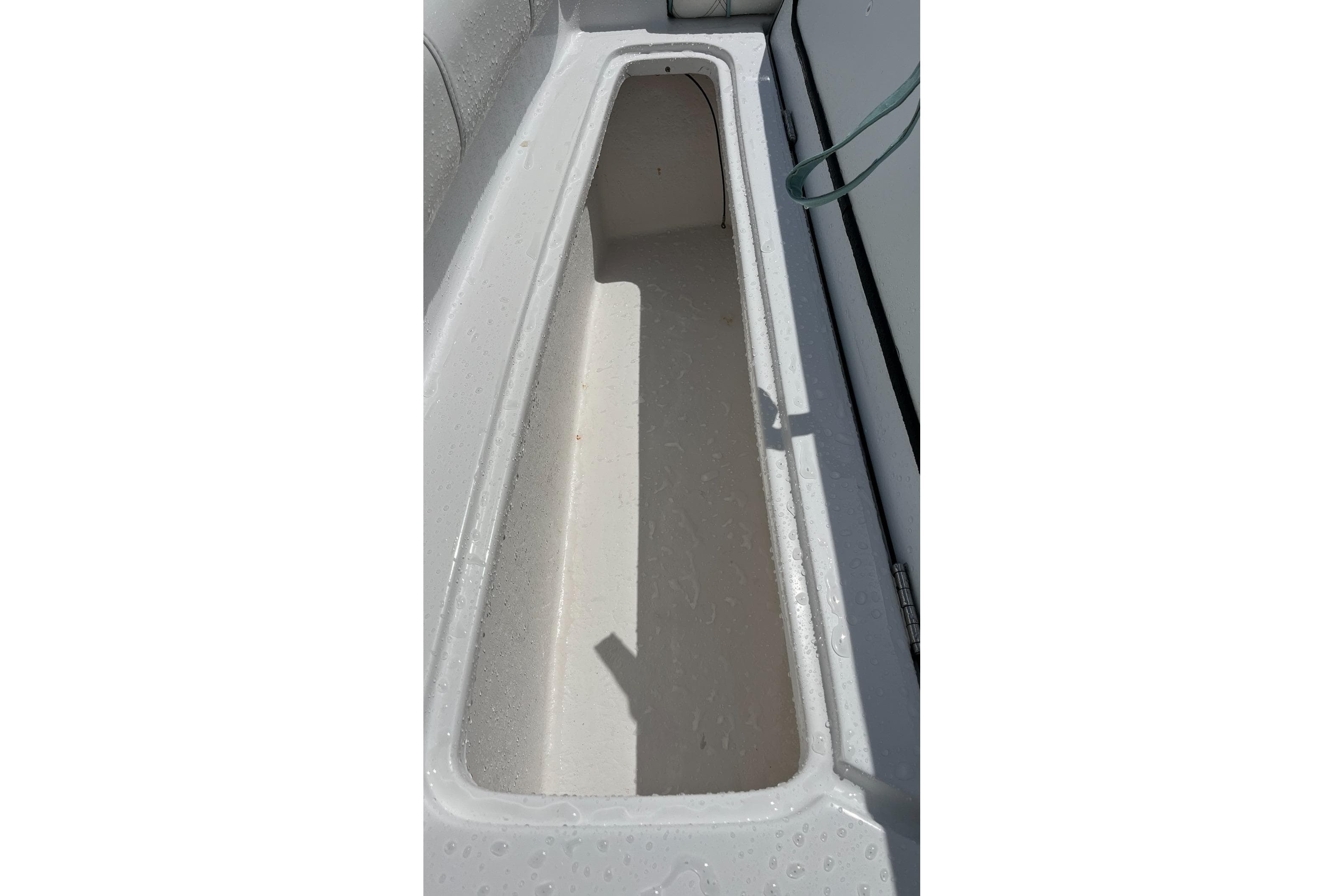 Storage compartment of 2021 Glasstream 255 Pro-XS boat, featuring a sleek, white interior.
