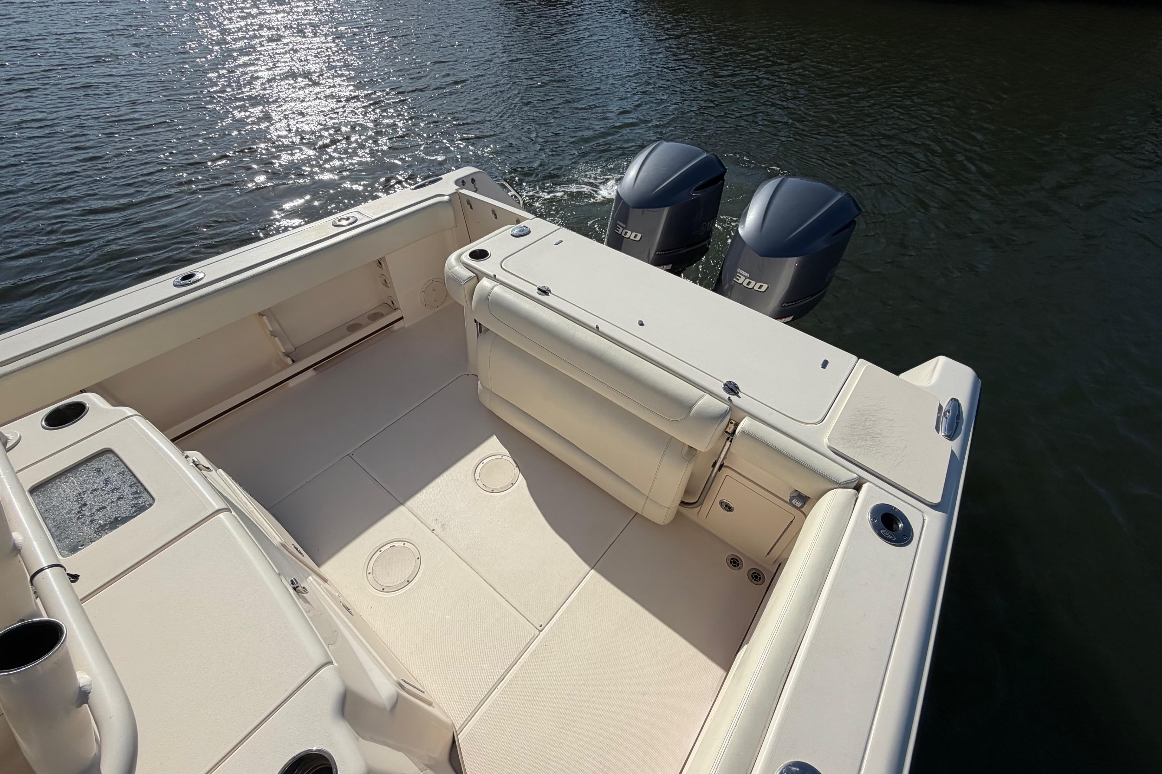 2018 Grady-White Canyon 306 boat deck with twin engines on water.