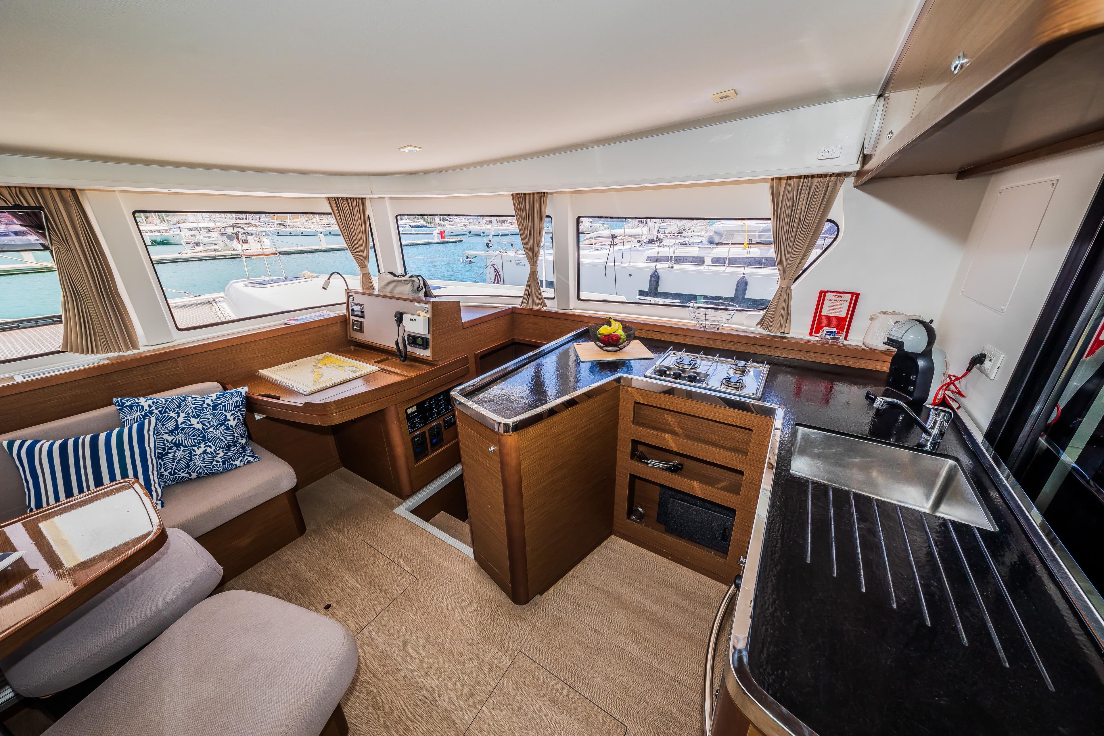 Interior of 2018 Lagoon 42 catamaran with modern kitchen and seating area.