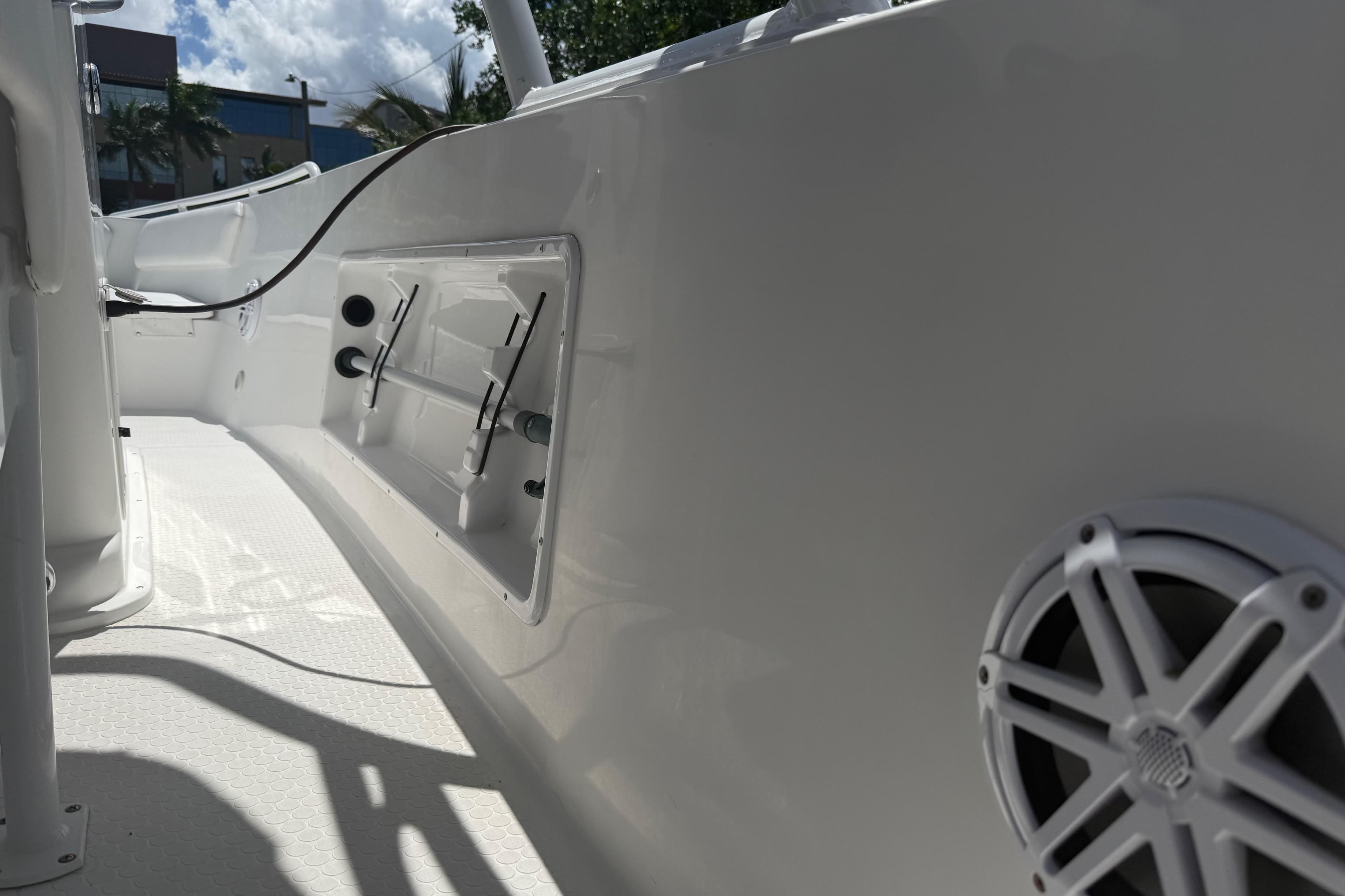 Interior view of a 2015 Concept 27 boat, featuring sleek white design and speaker system.