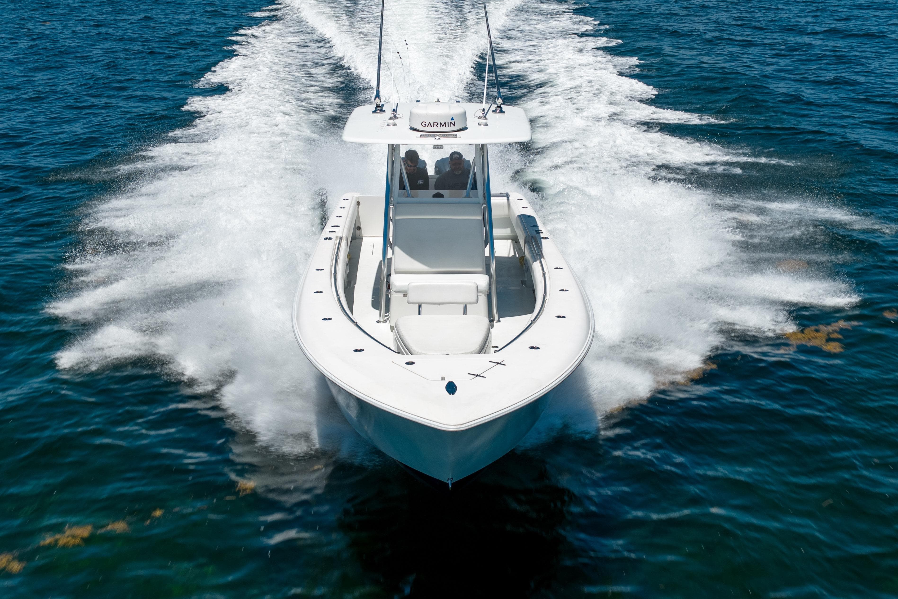 2022 Contender 35 ST boat cruising on open water, creating a dynamic wake.