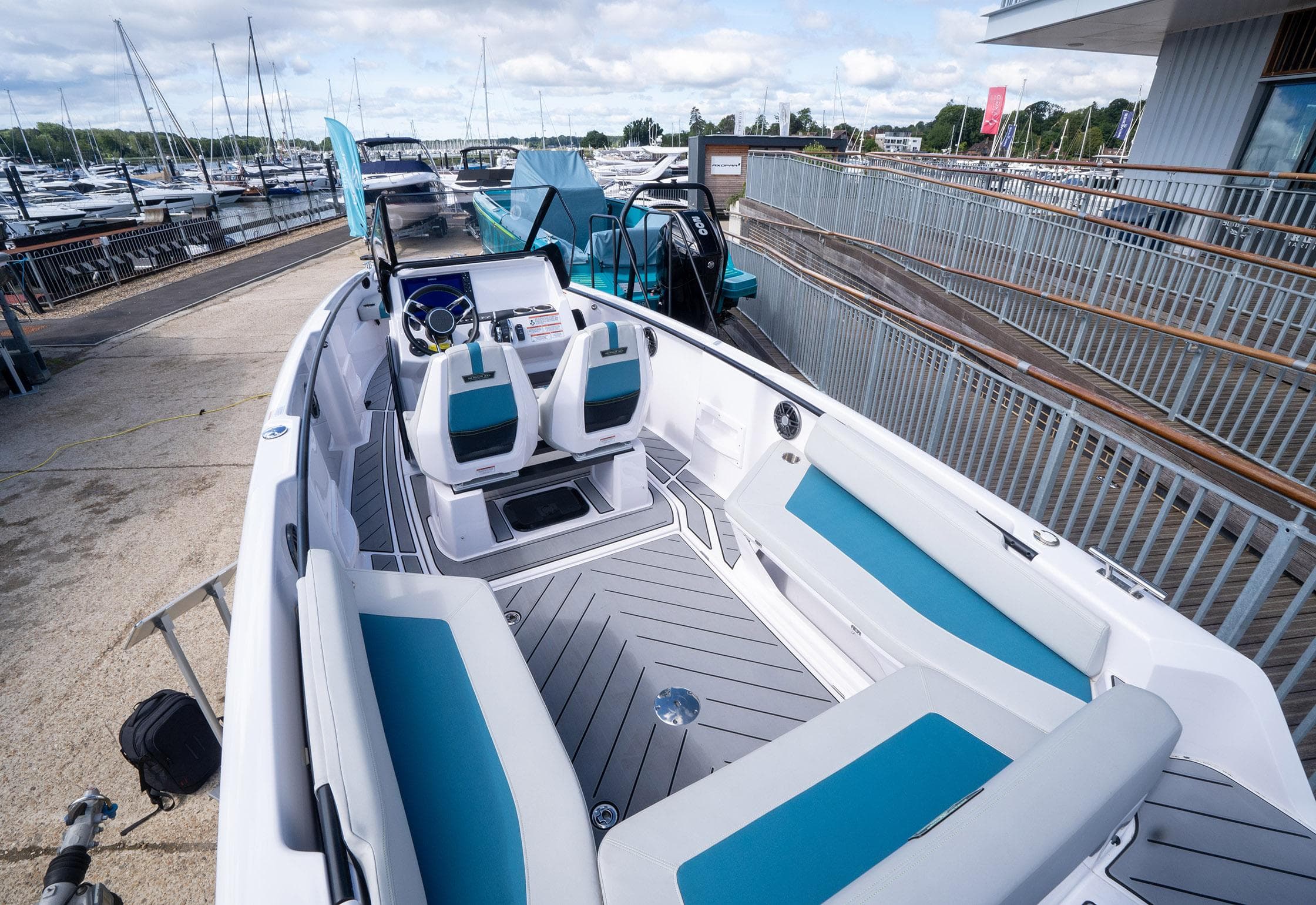 2022 Axopar 22 T-Top EX-Demo boat with modern seating and sleek design at marina.