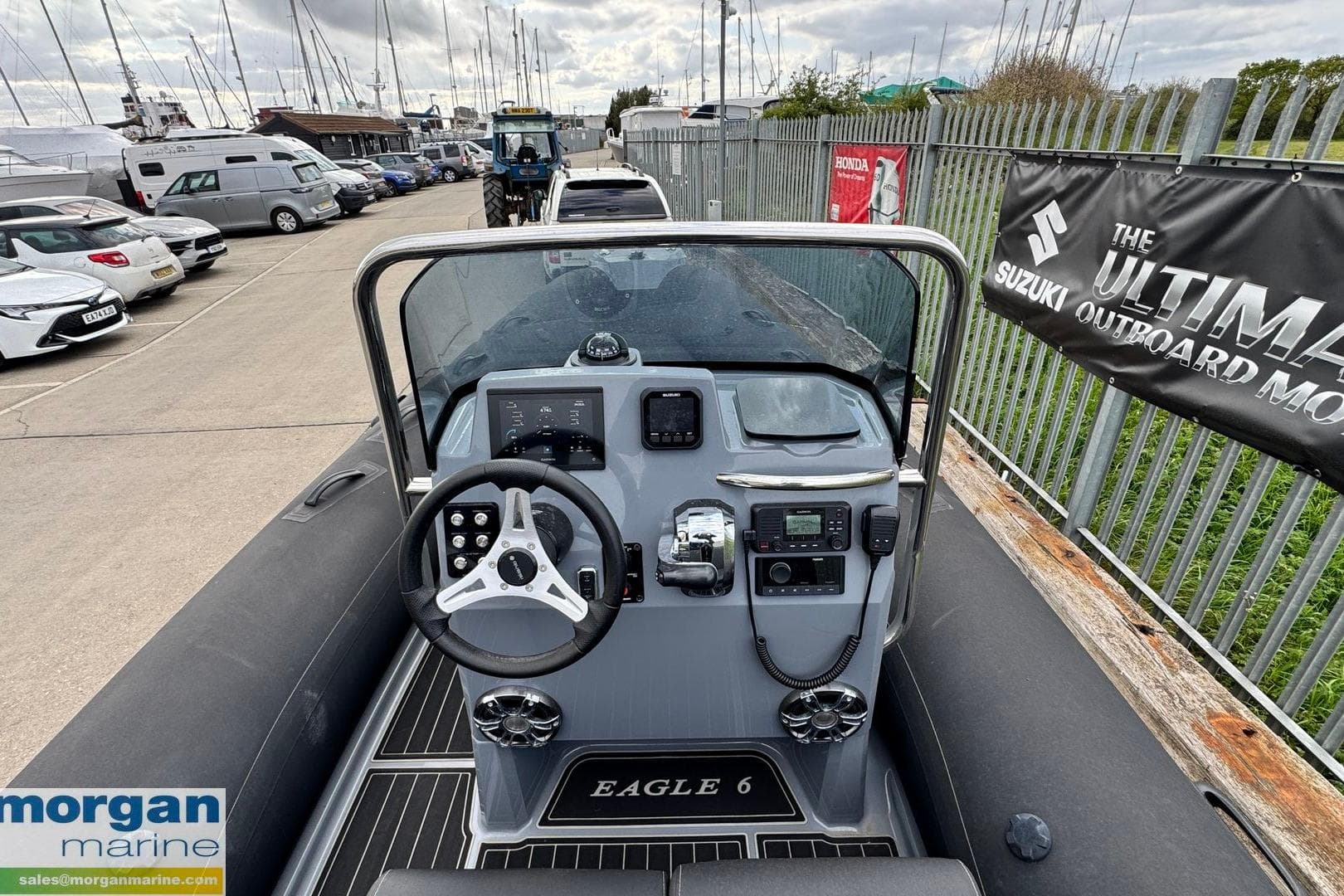 2023 Brig Eagle 6 boat dashboard with steering wheel and controls at marina.