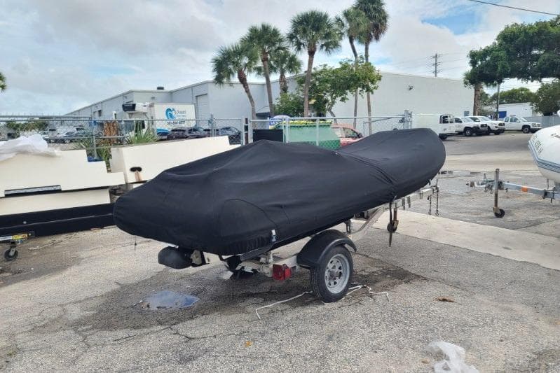 Covered Williams 385 boat on trailer, parked outdoors, 2015 model.