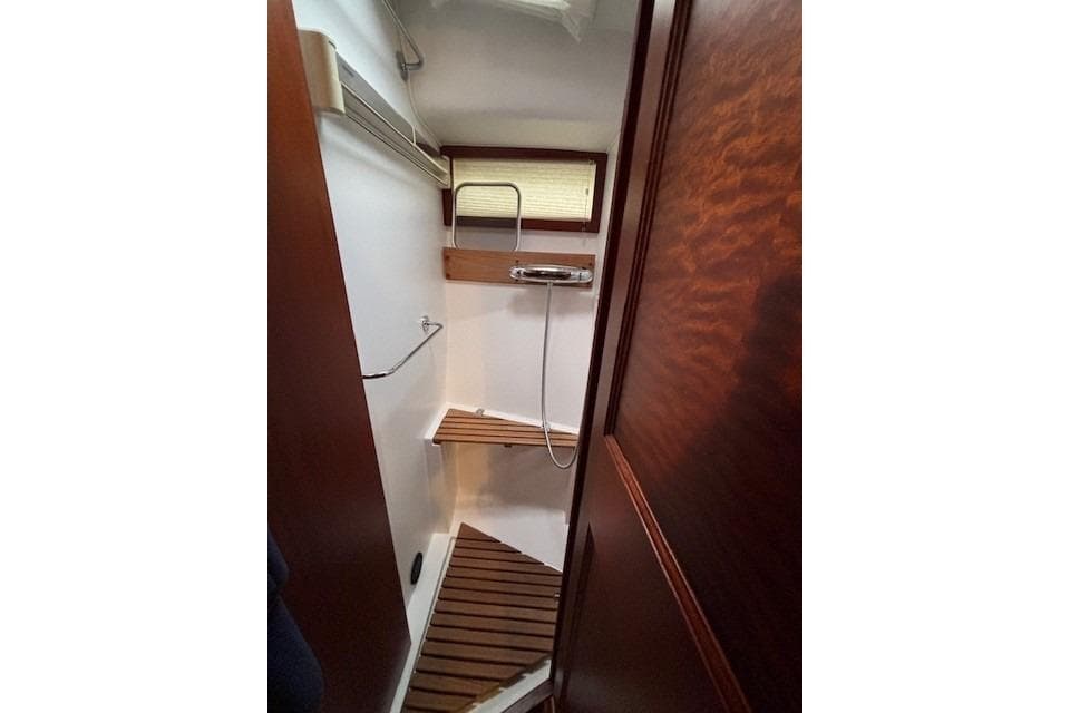 Shower area in 2000 Storebro Royal Cruiser 395 with wooden accents and modern fixtures.