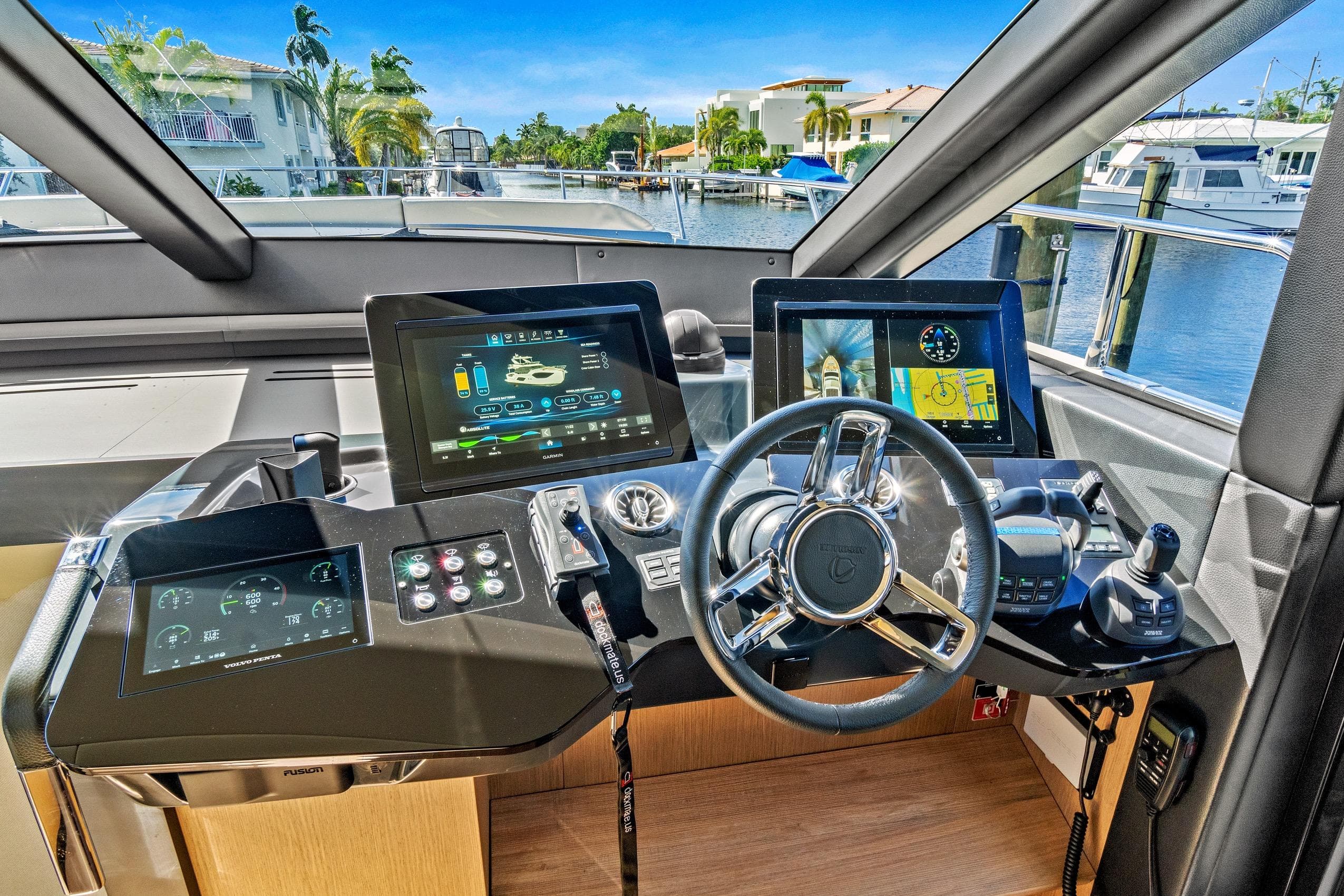 Cockpit of 2025 Absolute 52 FLY yacht with advanced navigation displays and controls.