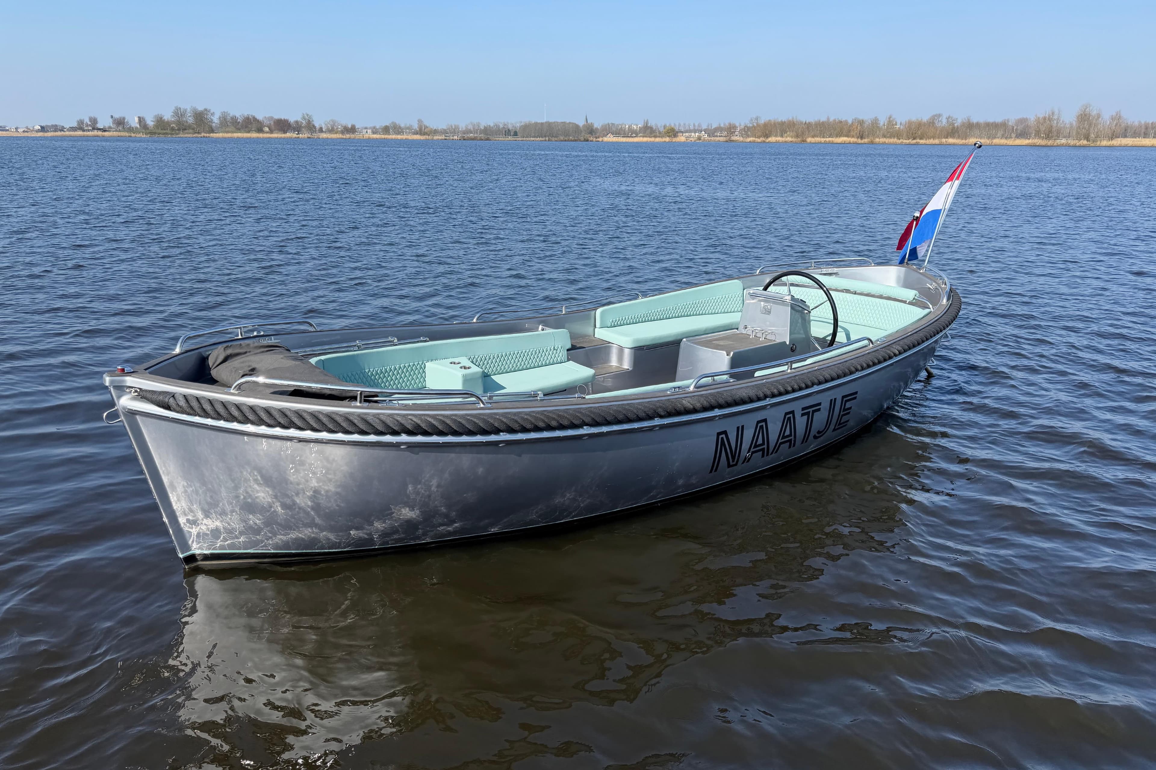 2012 Seafury 800 boat on calm water with Dutch flag.