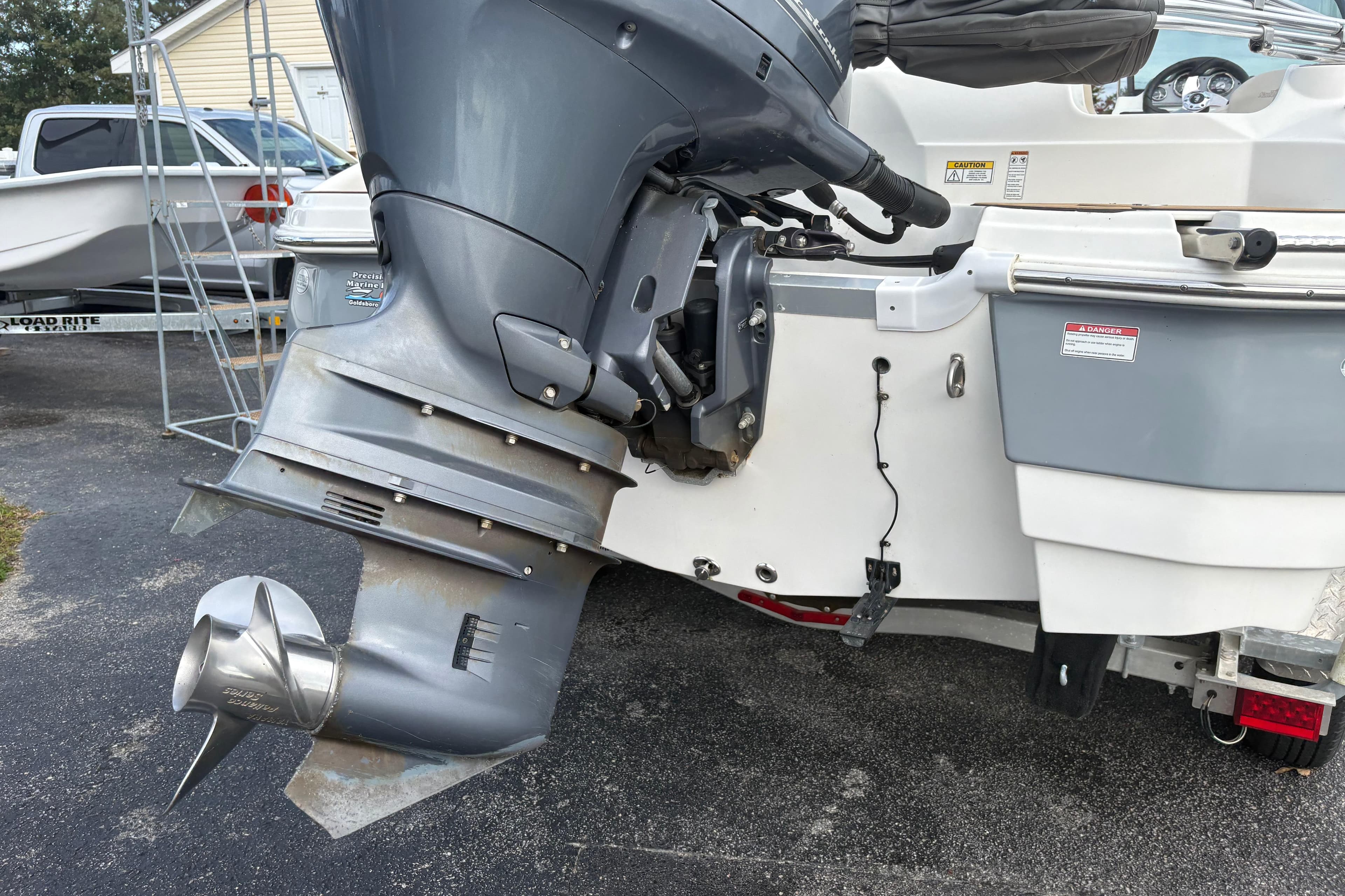 2022 NauticStar 203 DC boat with outboard motor, parked on a driveway.