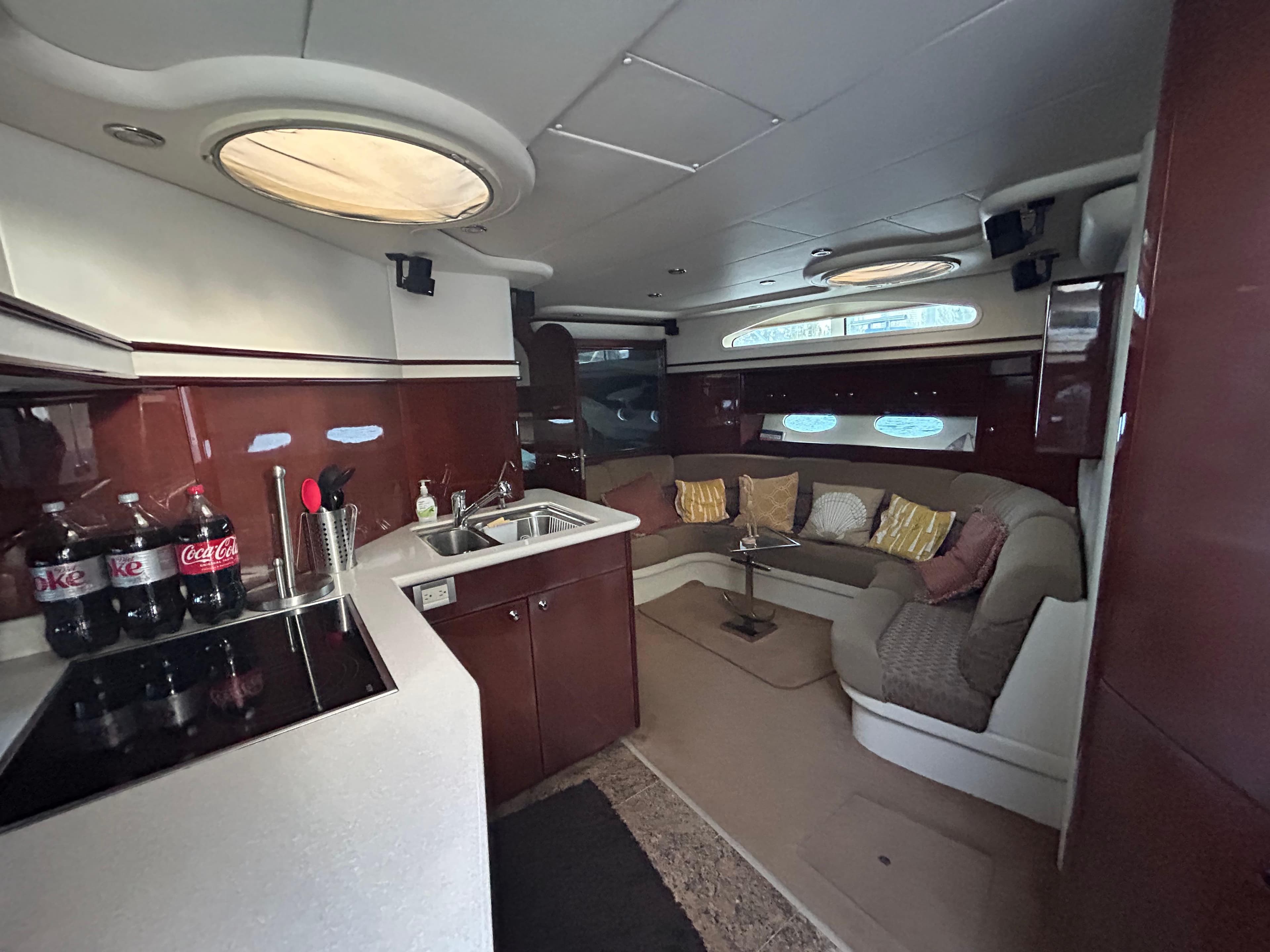 Luxurious interior of 2006 Neptunus 55 Cabrio yacht with modern kitchen and cozy seating area.