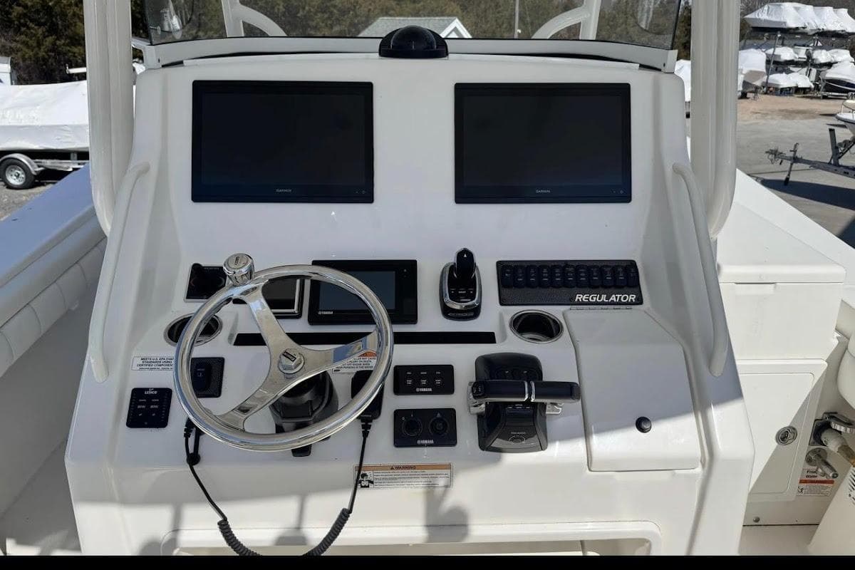 2018 Regulator 34 Center Console helm with dual screens and steering wheel.