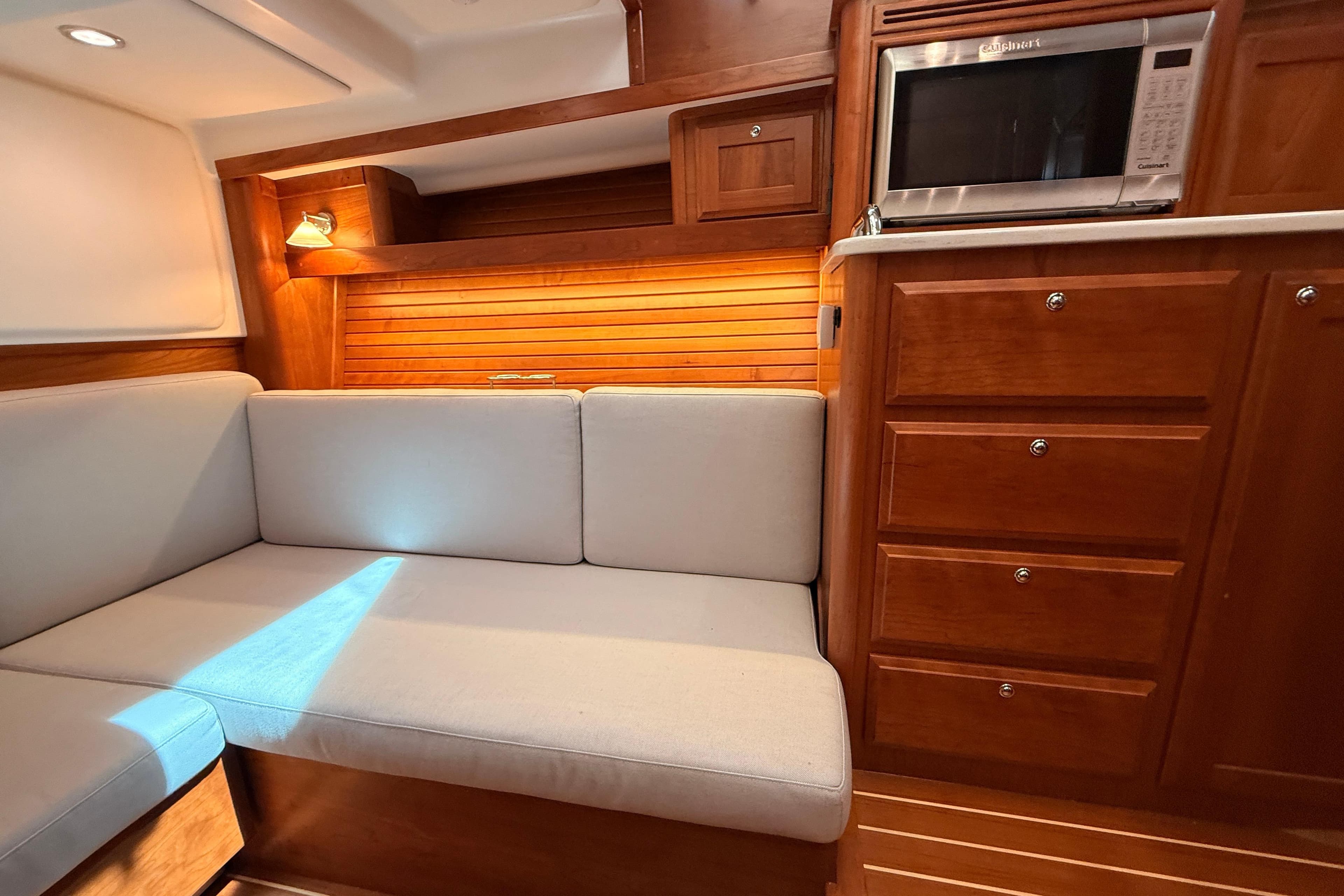 Interior of 2022 Sabre 38 Salon Express with cozy seating and wooden cabinetry.
