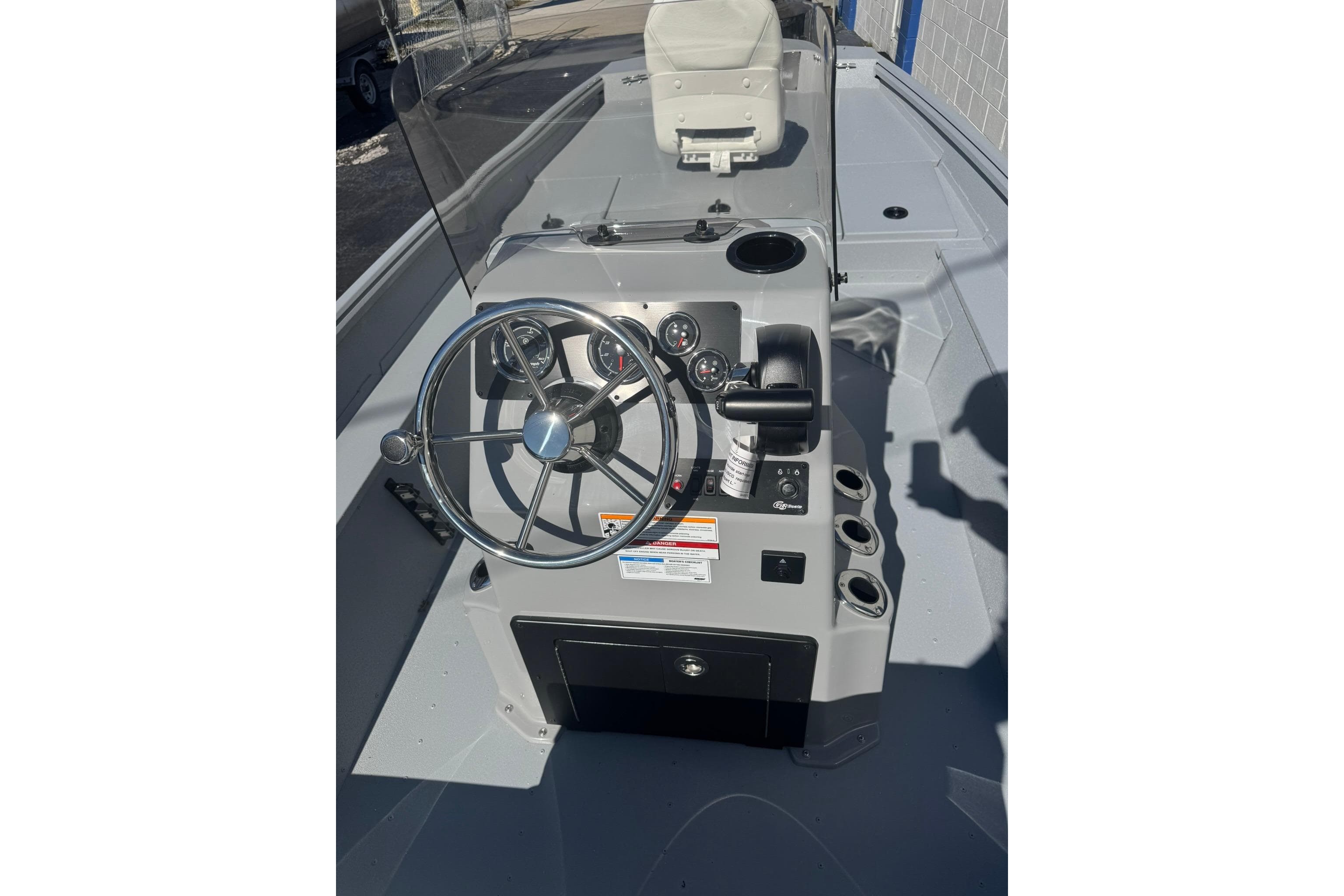 2026 G3 Bay 17 boat console with steering wheel and controls.