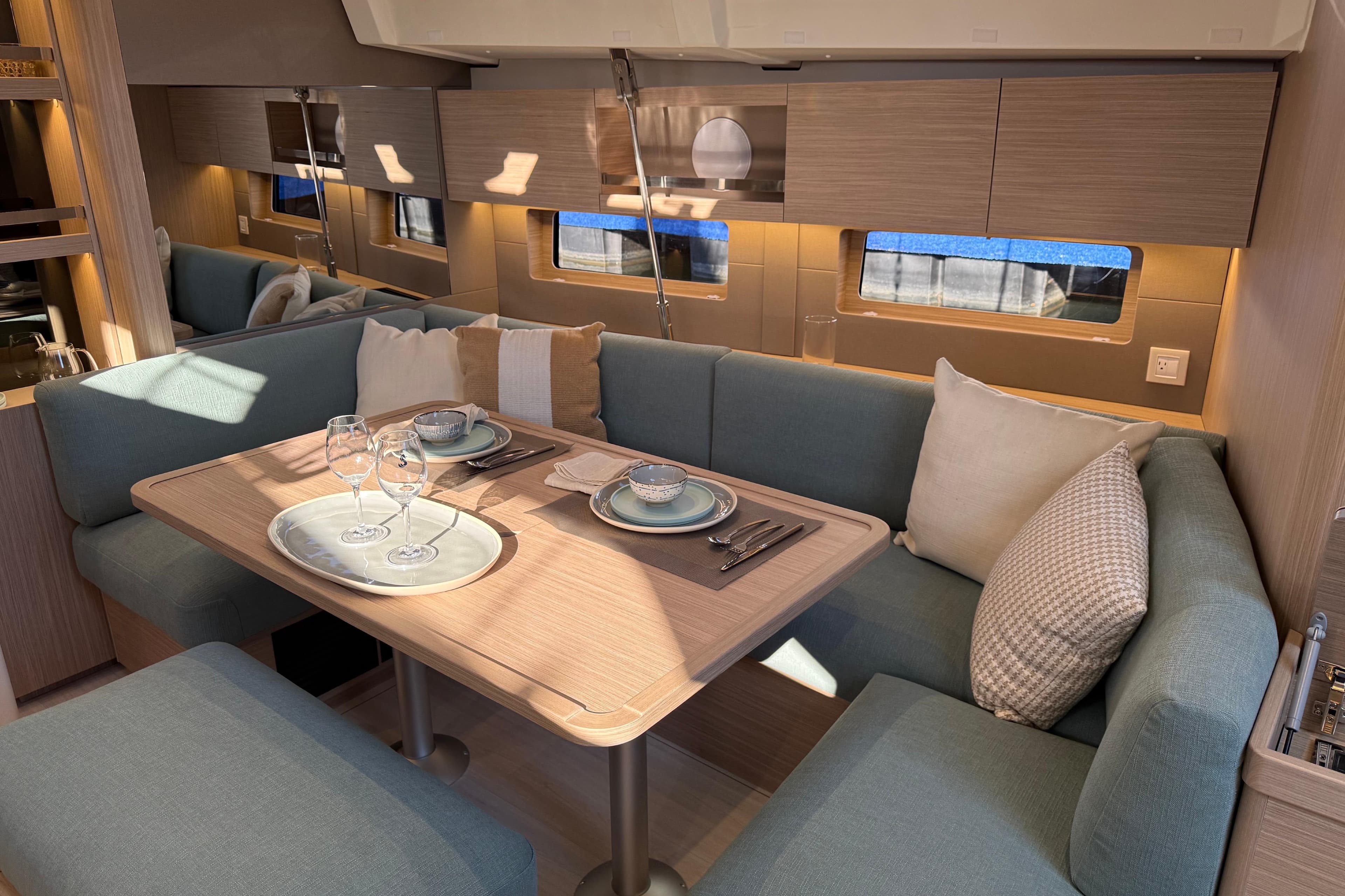 Luxurious interior of 2026 Beneteau Oceanis 47 yacht with elegant dining setup.