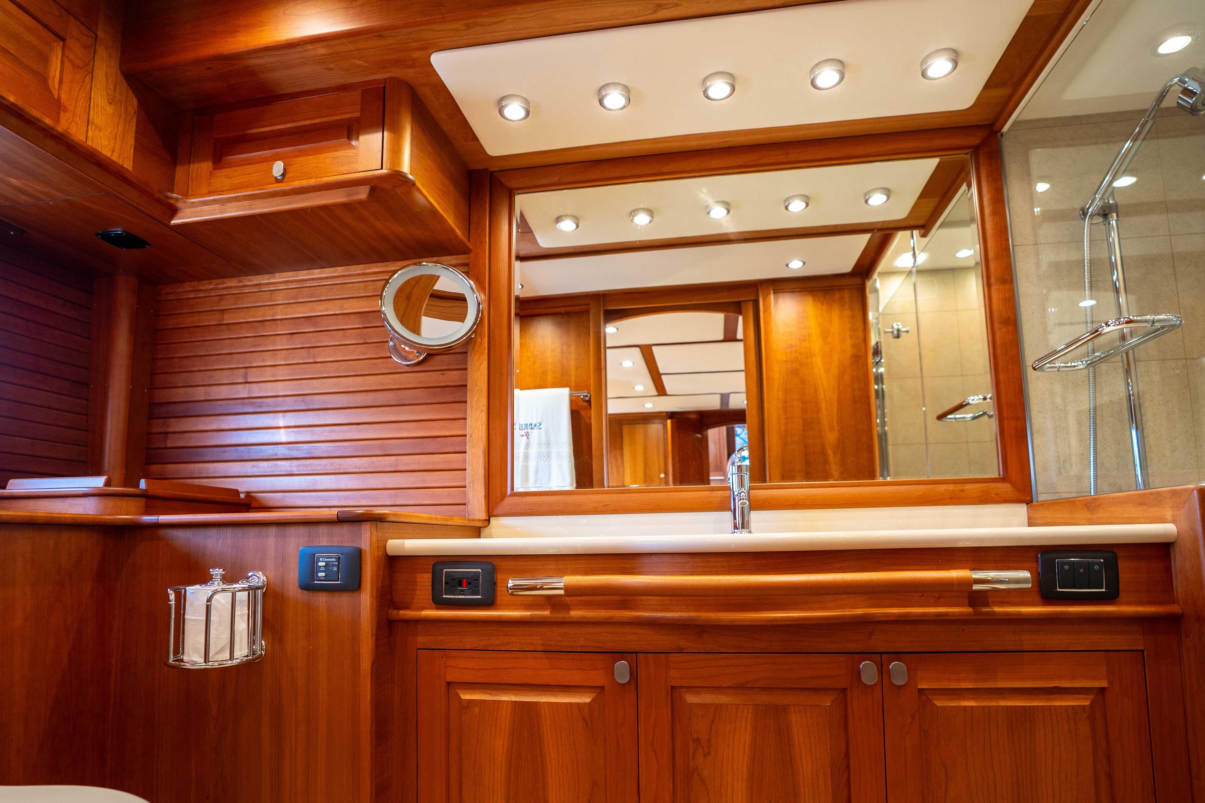 Luxurious wooden bathroom interior on 2018 Sabre 66 Dirigo yacht, featuring elegant fixtures.