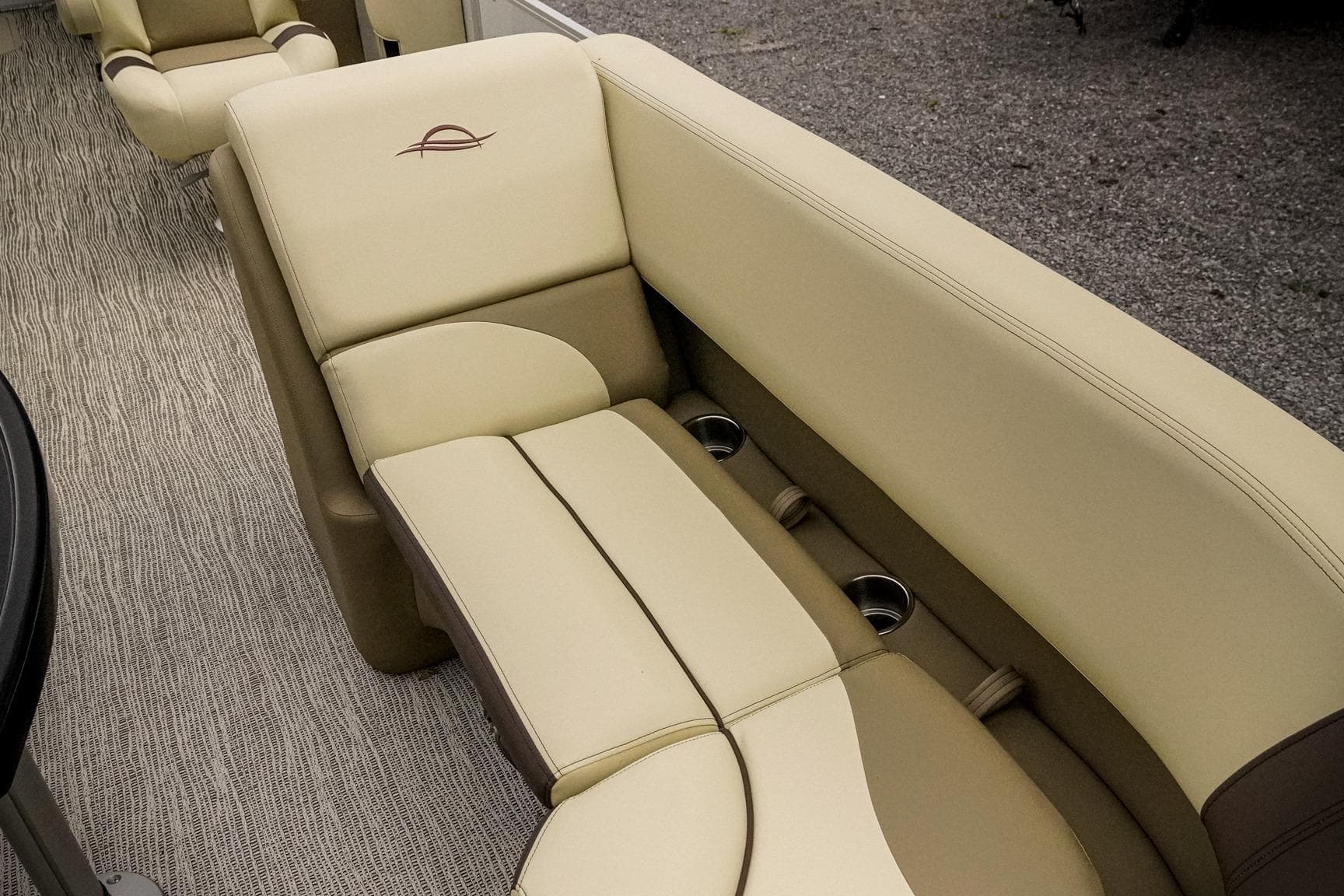 Luxurious seating in 2026 SunCatcher Select 22RC boat with beige upholstery and cup holders.