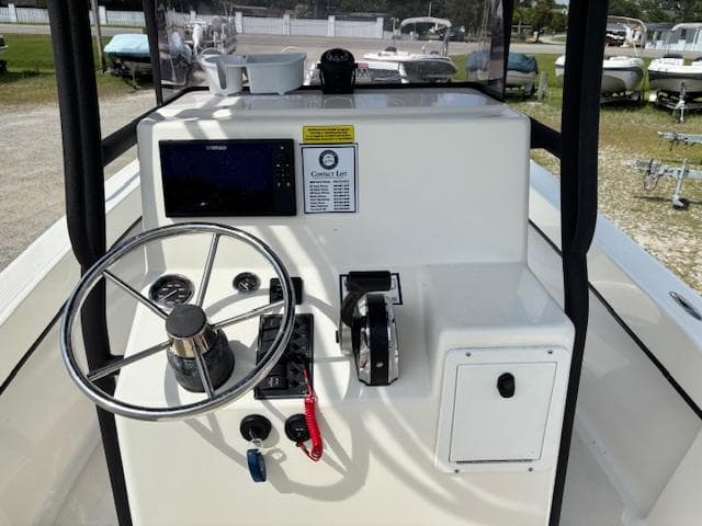 2022 May-Craft 2300 CCX boat console with steering wheel and navigation controls.