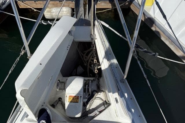 Bow of 2005 Beneteau 393 sailboat with anchor chain and winch system.