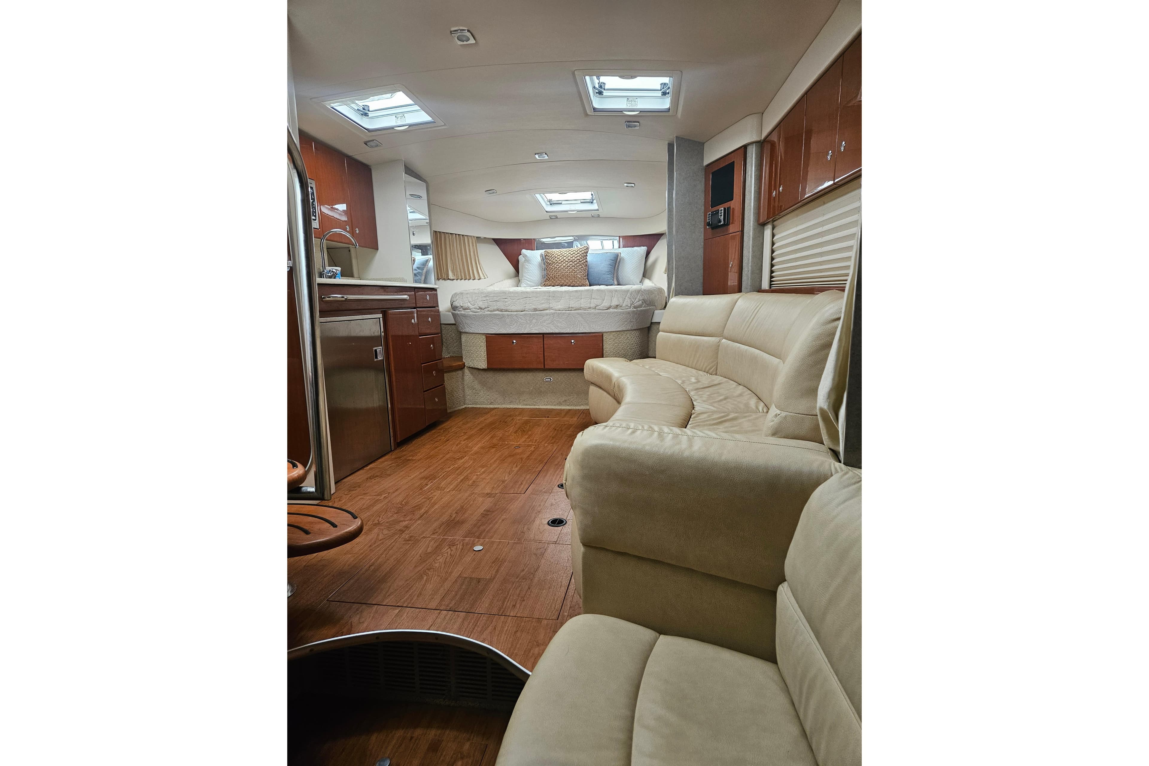 Interior of 2010 Formula 34 Performance Cruiser with modern furnishings and wood flooring.