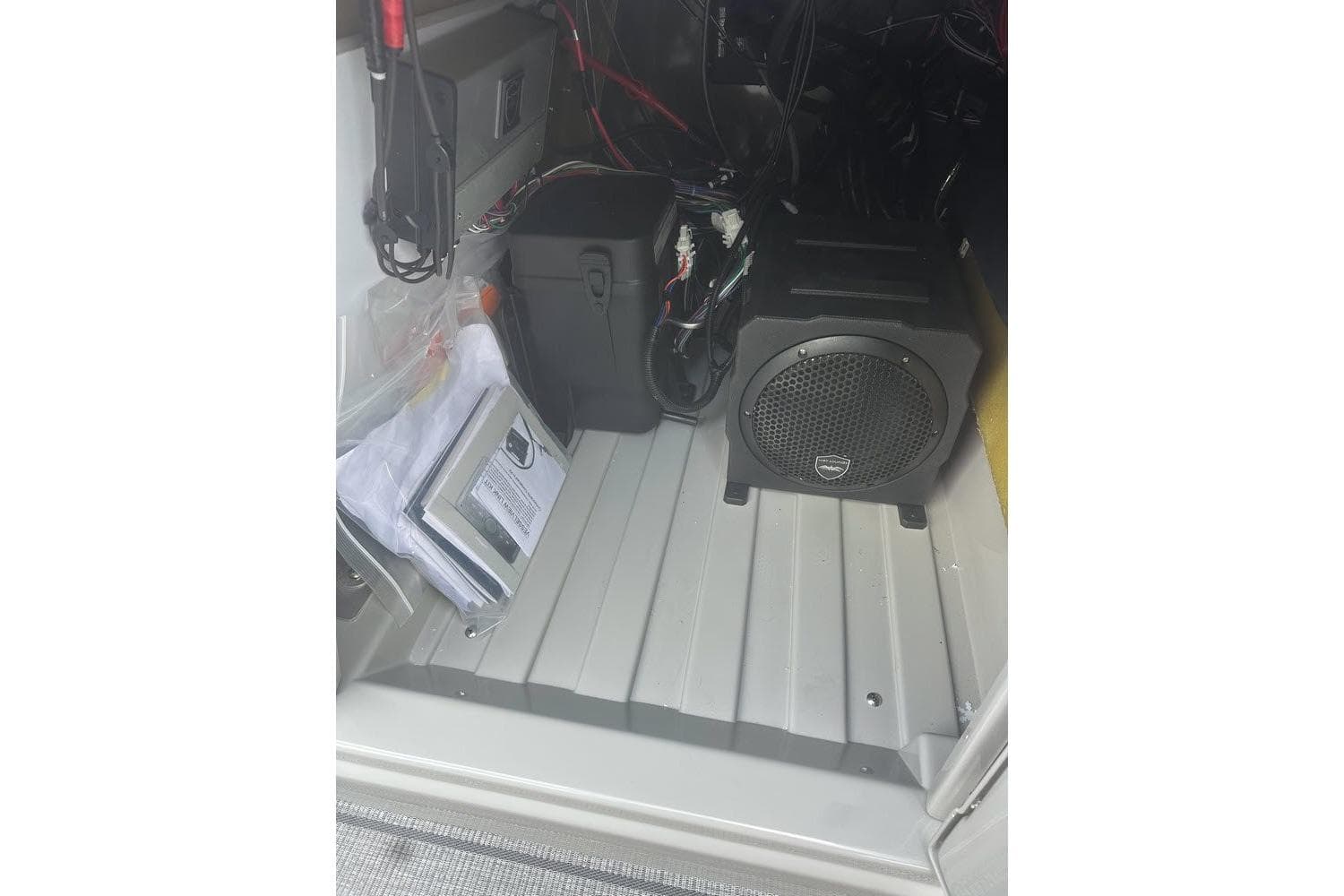 Interior view of 2026 SunChaser Eclipse 25 SBX DH BAR, showcasing audio equipment and storage area.