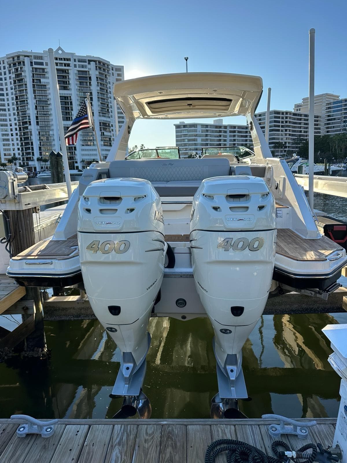 2021 Sea Ray SLX 310 OB with twin 400 horsepower outboard engines docked at marina.
