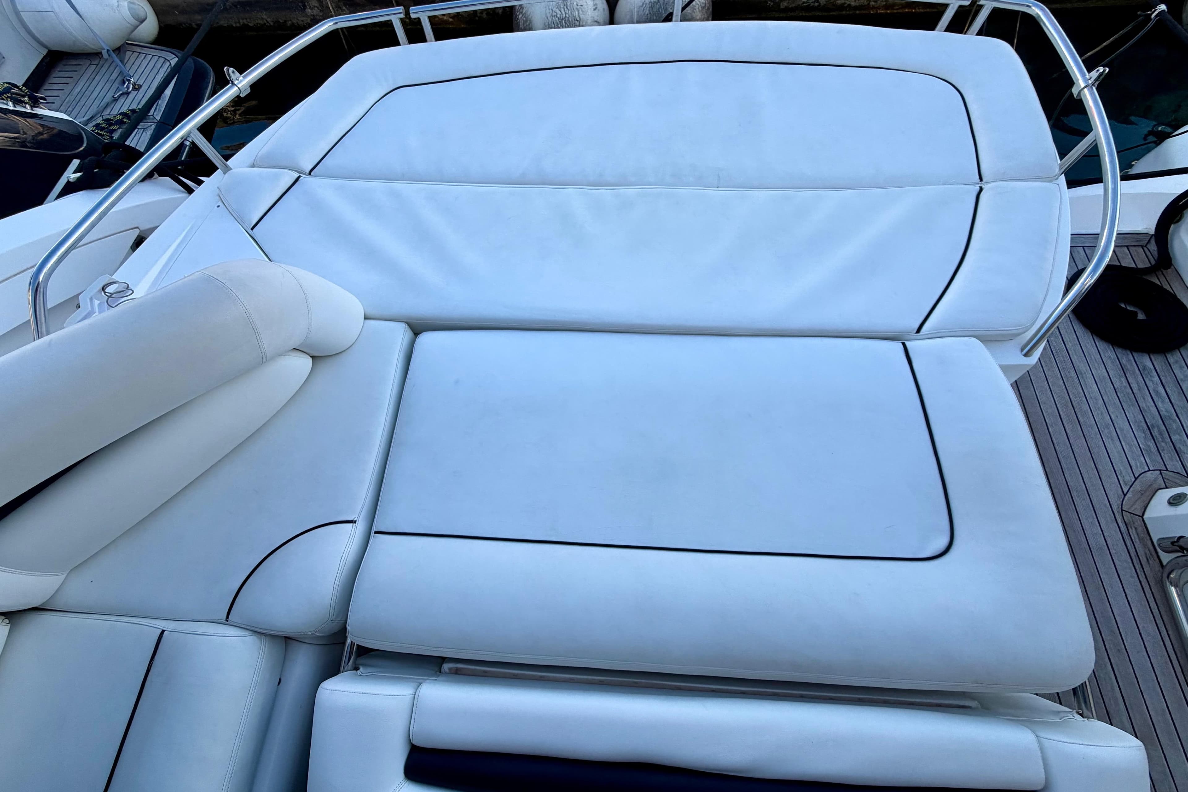Sunseeker Portofino 47 yacht's luxurious white seating area, 2006 model.
