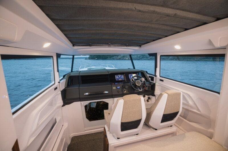 Interior of 2026 Axopar 38 Cross Cabin, featuring modern helm and seating.