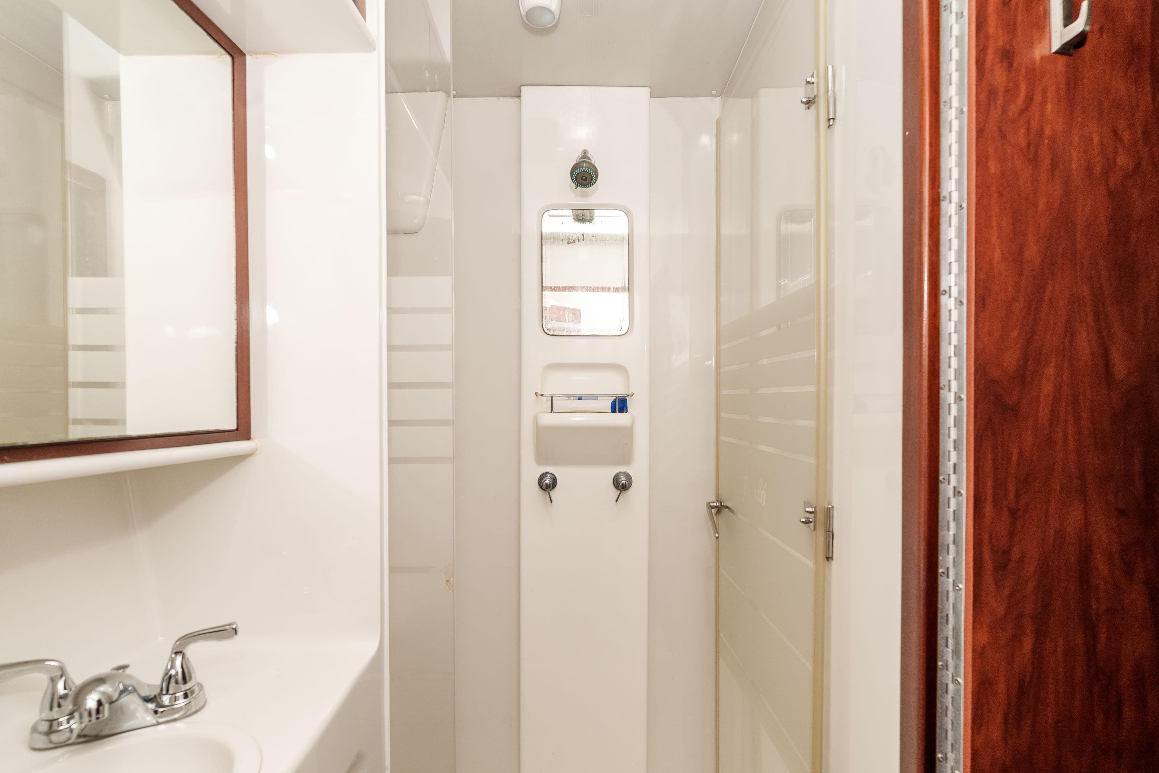 Bathroom interior of 2009 Kelsall KSS 58 yacht, featuring shower and sink.