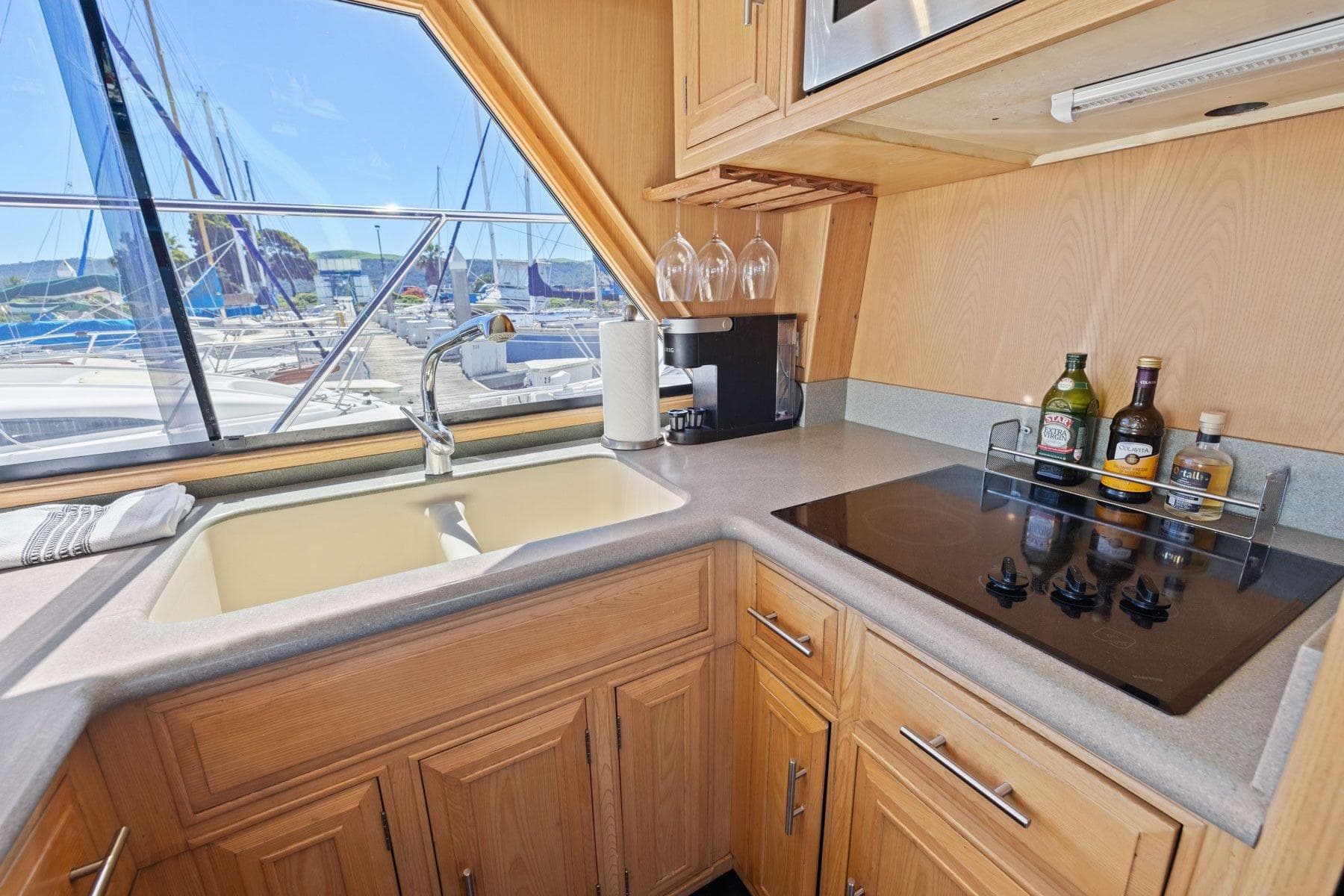 1991 Ocean Alexander 520 Pilothouse kitchen with sink, stove, and marina view.