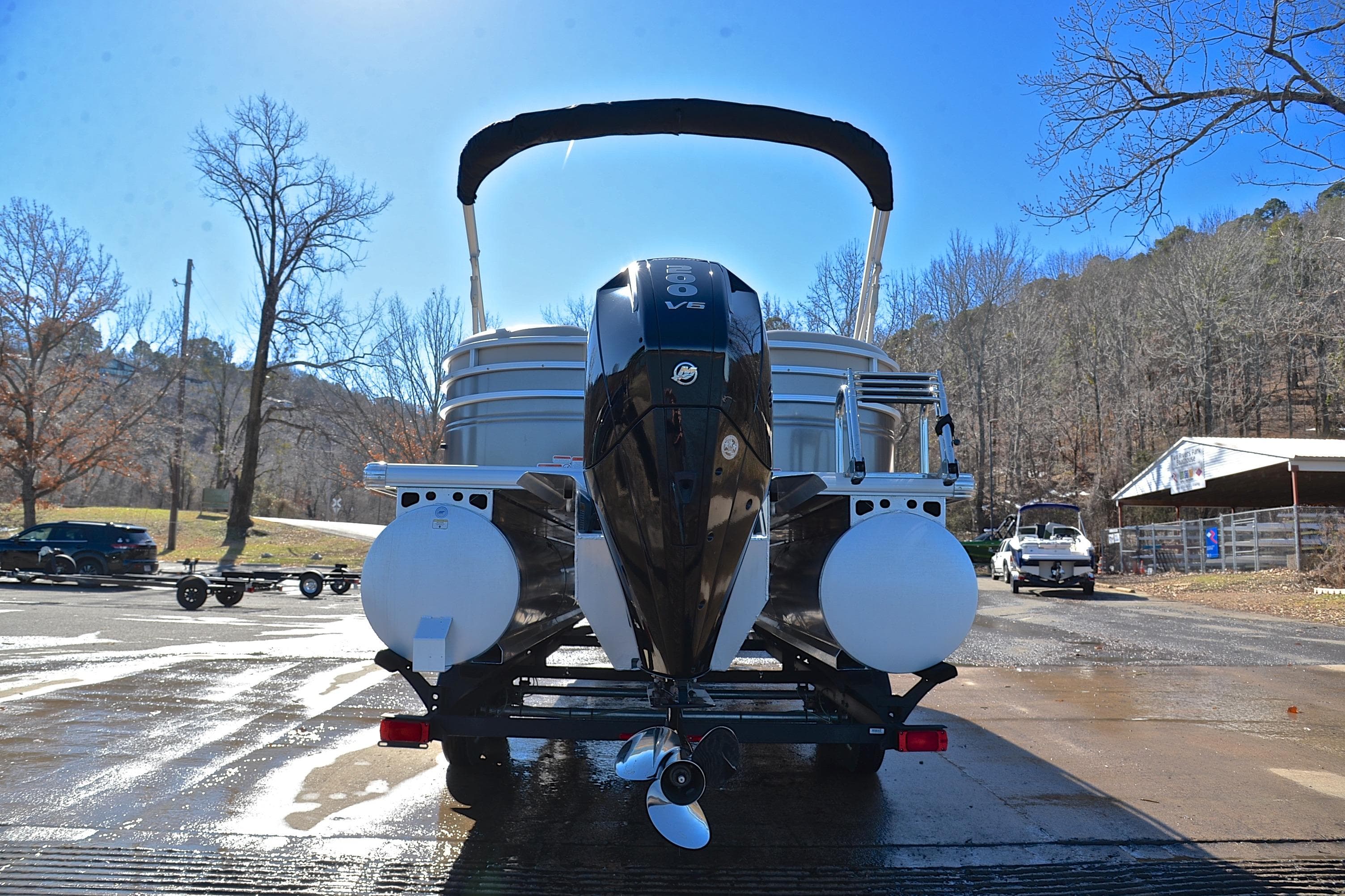 2024 Sun Tracker Party Barge 22 XP3 pontoon boat on trailer, rear view.