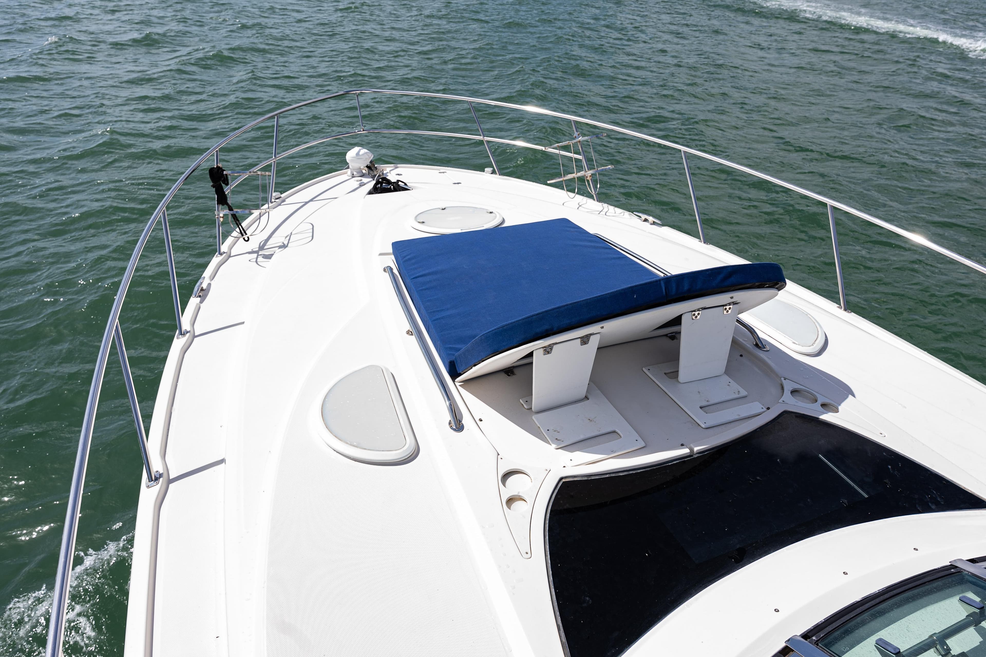 2008 Monterey 400 Sport Yacht deck with blue sunpad on open water.