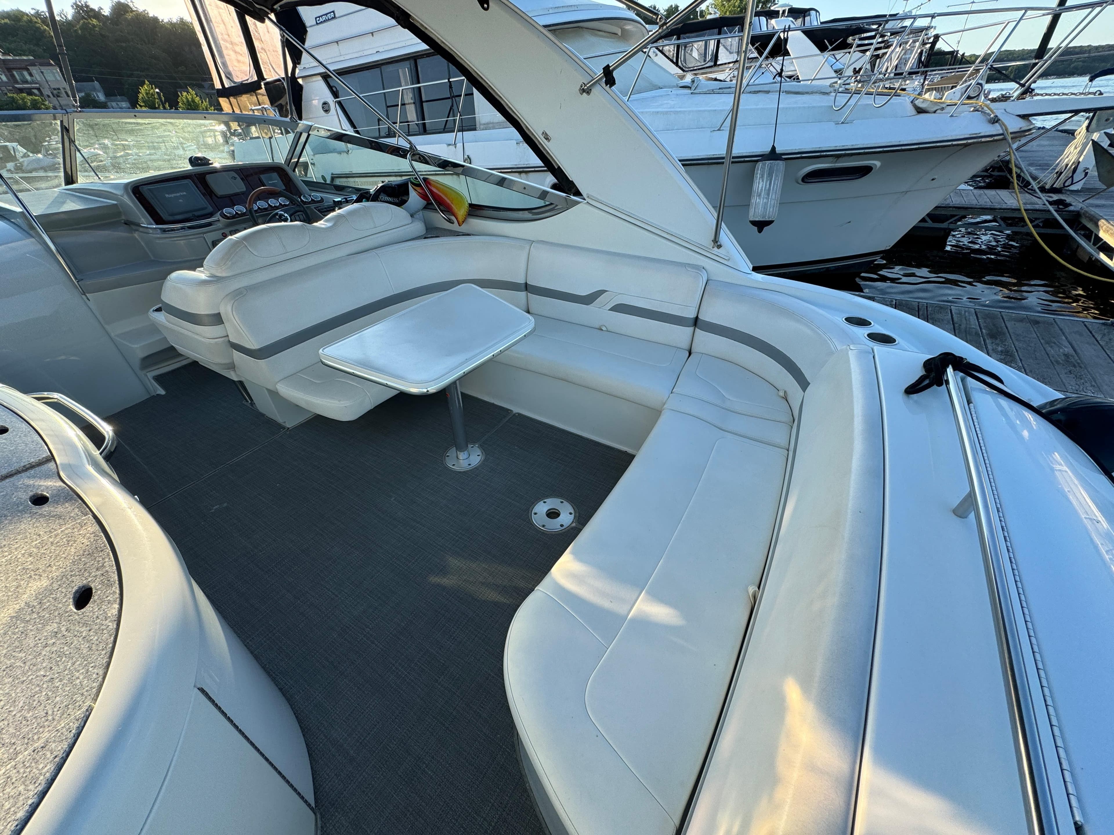 2006 Formula 370 SS boat interior with white seating and table, docked at marina.