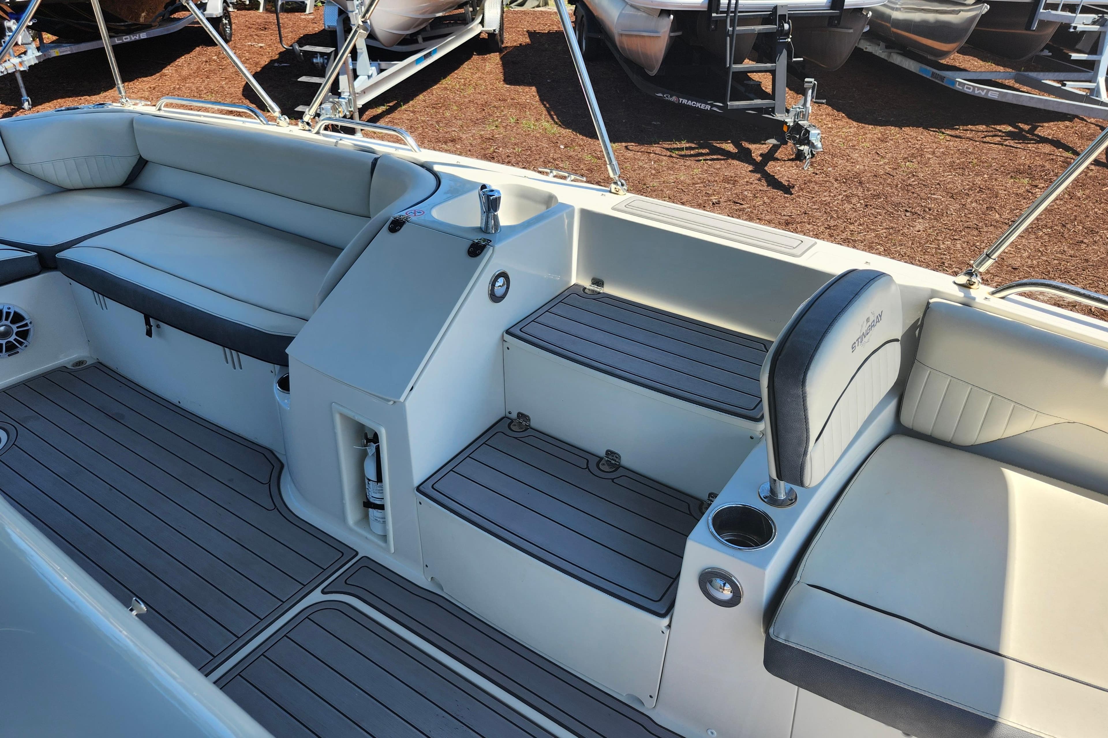 2024 Stingray 212 SC boat interior with seating and storage compartments.