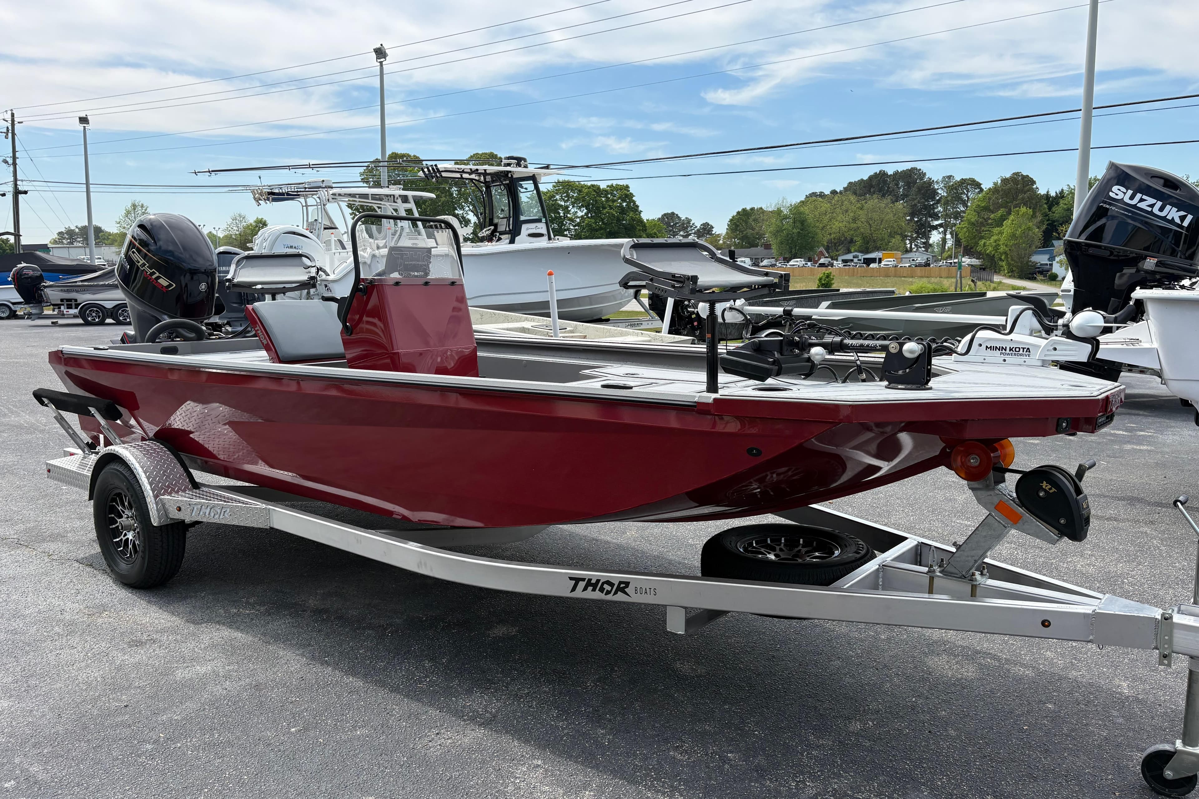 2025 Thor Lake Hammer 1900CC Elite boat on trailer, red exterior, parked outdoors.